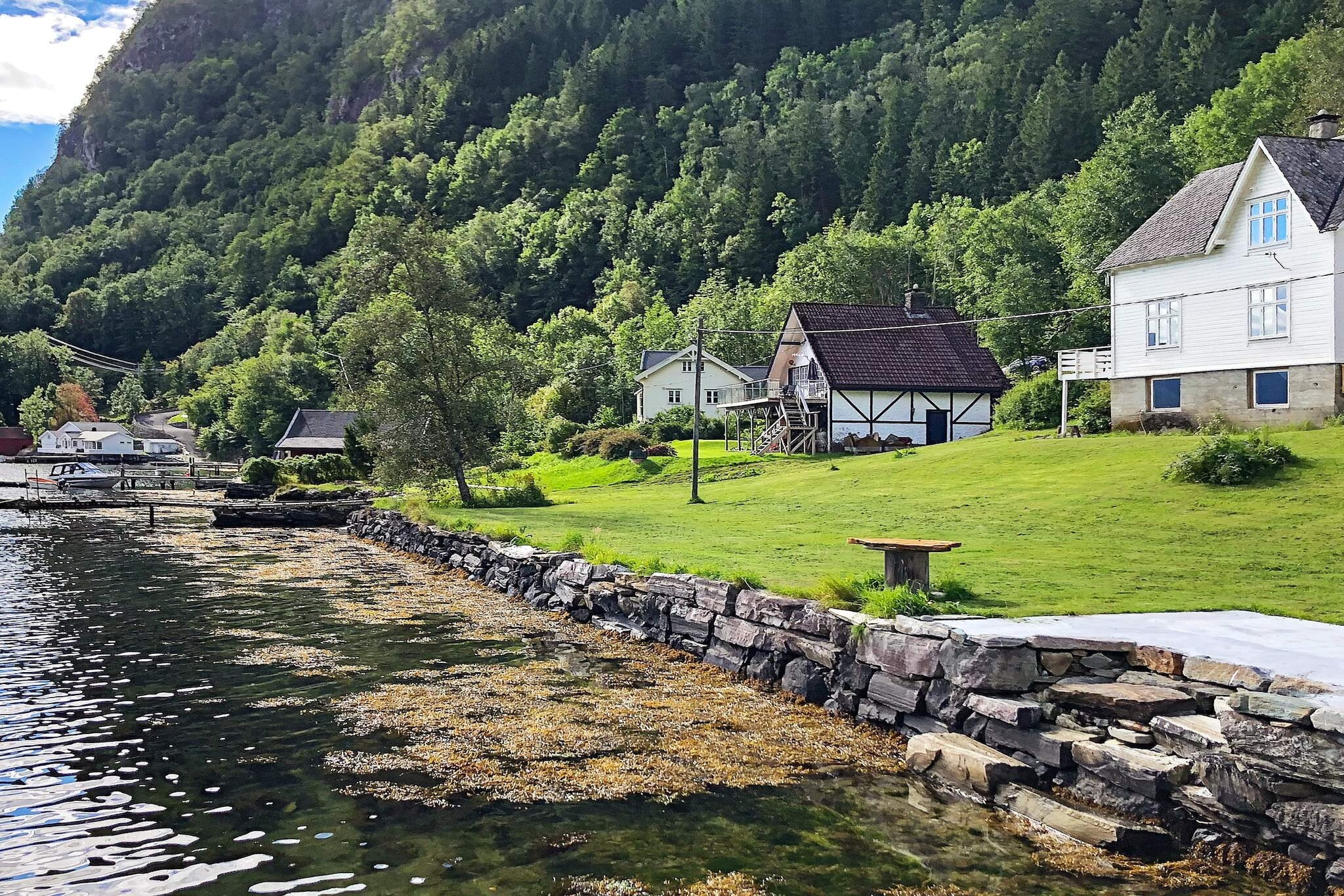Magnificent holiday home with large balcony and beautiful views of the Hardangerfjord. Panoramic views far inland to the mountains by Fyksesundet and to the fantastic mountains towards Folgefonna. The holiday home, which was renovated on the 1st and 2nd floor in 2018, is practical and comfortably furnished. In the living room you can enjoy the warmth of the fireplace on cold days while enjoying yourself in front of the TV which has international channels. Norwegian TV is NRK1, 2 and 3. Free wireless internet 20 Mbits speed for streaming. In one of the two bedrooms with a single bed, the bed is 120 cm wide. 35 m from the holiday home there is a yellow boathouse with living room that can be opened to the fjord, here is also a kitchenette (2 hotplates, water, refrigerator etc.), this is included in the rent. Both here and on the balcony of the holiday home you can eat good meals surrounded by beautiful nature. For rent is a 14 foot boat with 6 hp engine, a short distance to good fishing spots. Fish filleting place by the boathouse. Great swimming opportunities from own shoreline only 20 meters from the house. It is about 35 minutes drive to the extreme sports area Voss, and only 1.5 hours to the capital of Western Norway and Norway's second largest city; Bergen.