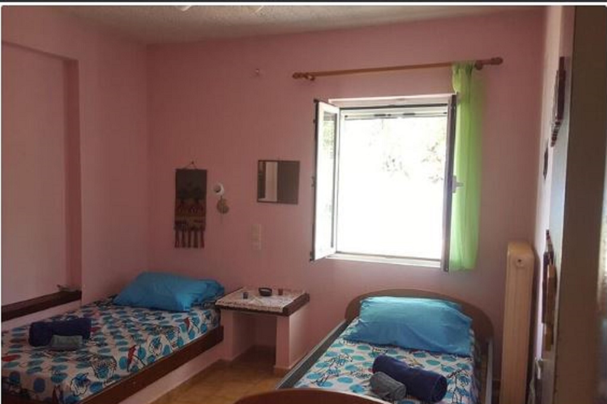 Ground floor: (Living room(TV, dining table, fireplace, seating area), Kitchen(oven, fridge), bedroom(bunk bed, bunk bed, bunk bed), bedroom(double bed), bathroom(bath tub, shower, toilet), washing machine, air conditioning, terrace, garden, bicycle storage, garden furniture, BBQ, parking, deckchairs, play equipment, play equipment, iron)