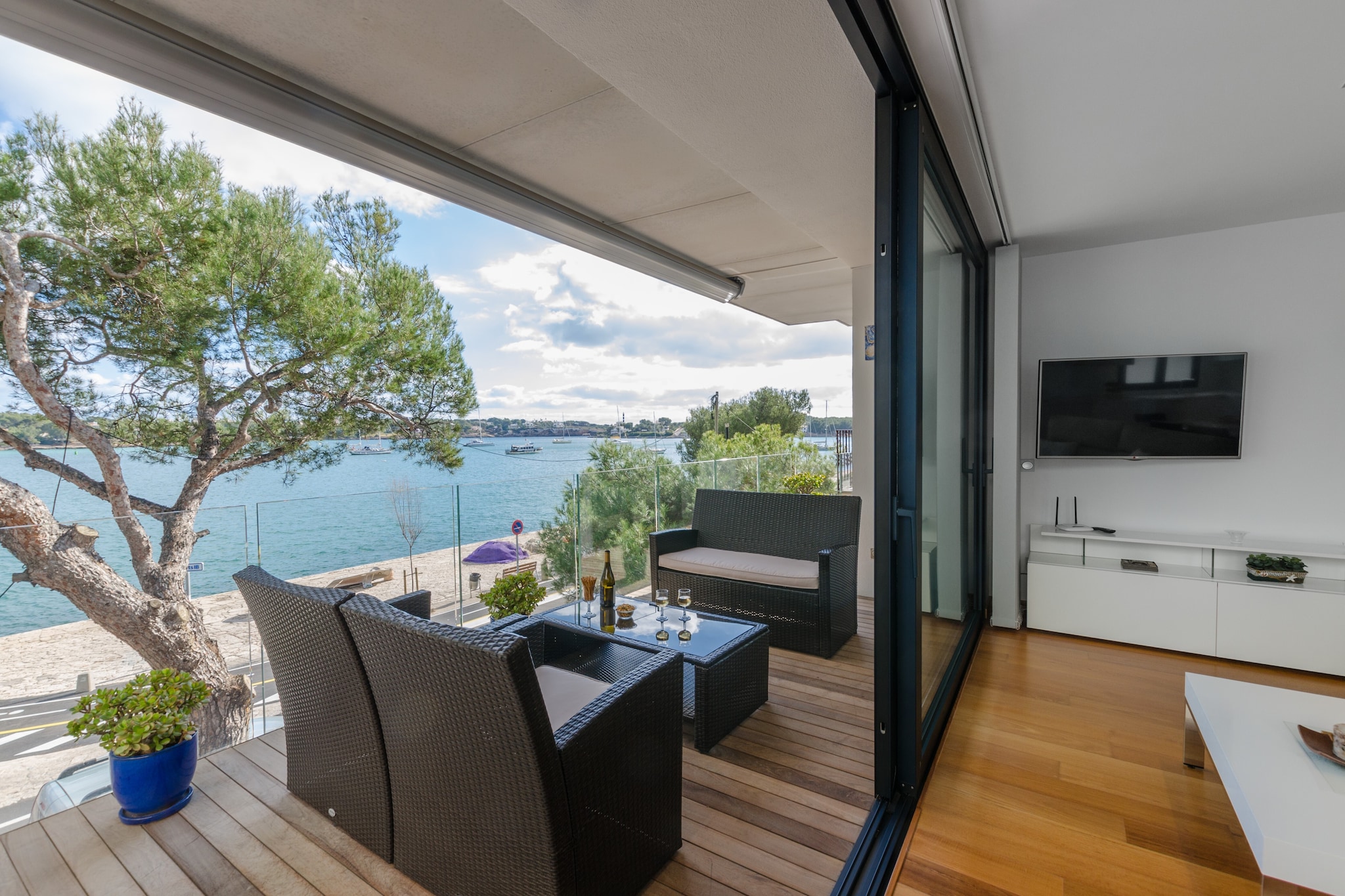 The great terrace of this apartment is perfect to spend the nicest moments with the company of the spectacular views to the marina and sea of Portocolom. The sunrises and sunsets from here, while feeling at the same time the sea breeze and the soft chant of the waves and enjoying a coffee or a glass of wine and an appetiser, will be absolutely unforgettable.

The apartment is located on the first floor of the building and there is no lift. It combines charm and comfort thanks to the beautiful rooms with wooden floors and the perfect furniture and details. The living room, the dining room and the kitchen are together. Here you can relax while watching the satellite TV or chatting with the sea views at the end. The kitchen is equipped with a ceramic hob. There are 3 bedrooms in the apartment, two with single beds and the last one with a double bed, a TV-set (with Spanish channels only), en-suite with independent bath and shower and exit to the terrace. Two of the bedrooms offer a walk-in closet and the last one has a dresser. There is baby cot and a high-chair and a second bathroom with a shower for the rest of the house. The apartment is equipped with conduit air-conditioning. The laundry room features a washing machine, a tumble dryer, an iron and an ironing board.

The location is a privileged one since the apartment is on the seafront of Portocolom. With the marina right in front, you can take pleasant walks whilst admiring the boats. The beach of Cala Marçal is 1.5 km away. The town centre offers all needed services like bars, shops, restaurants and supermarkets. And if you love playing golf, the course of Vall d'Or is only 6 km away. Consult the advertiser for possible charges. Pets are not allowed. The holding of events is forbidden. 
Distances
Beach: 1.5 km - Cala Marçal
Airport: 59.5 km - Son Sant Joan
Golf course: 5.6 km - Club de golf Vall d'Or
Town: 0 km - Portocolom
Train station: 24.6 km - Manacor
Bus stop: 2.6 km - Portocolom
Ferry: 67.3 km - Palma
Hospital: 25.3 km - Hospital de Manacor
Tourist license: ETVPL/12866Single Rental Registry: ESFCTU00000700800115884600000000000000000ETVPL/128665The Ecotasa (tourist tax) must be paid cash on site when checking in. The amount varies between 0.55€/night and guest during the low season and 2.2€/night and guest during  the high season. The tax is reduced by half from the 9th day of your stay. All guests have to pay the Ecotasa, except people under 16 years. Homerti - Central de Reservas CR/33