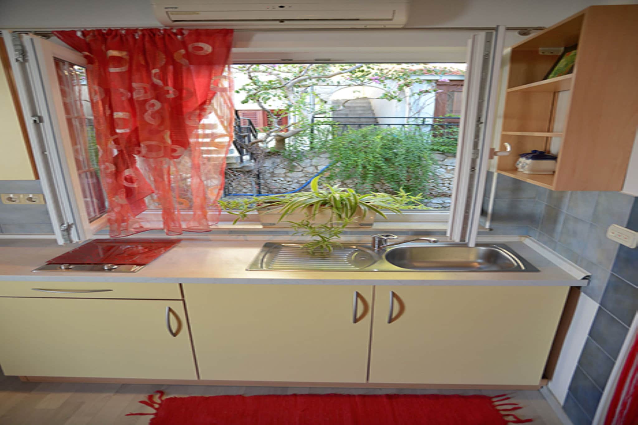 Intimate Seaside Studio for Two
Experience a "warm sense of arrival" in this compact and bright 16 m² apartment, perfectly tailored for a romantic escape or a solo traveler. Located on the first floor, the space features a comfortable double sofa bed and a cozy living area with a flat-screen satellite TV. Bathed in natural light, this charming studio offers an inviting sanctuary where you can relax in total comfort, featuring full air conditioning to ensure a perfect temperature during the warm Mediterranean afternoons.

Coastal Living and Social Spaces
One of the unique highlights of this property is the 24 m² shared open kitchen and lounge area, accessible via an outside stairway. This social hub is equipped with a grill and spacious seating, ideal for preparing fresh local meals and meeting fellow travelers. Additionally, your apartment includes a private balcony, providing a peaceful outdoor nook to enjoy the sea breeze and a morning coffee before heading out to explore the stunning coastline.

Unbeatable Proximity to the Beach
Location is the true star of this stay, situated just 40 meters from Brzet North Beach. Whether you prefer a quick morning swim or a full day of sunbathing, the crystal-clear waters are practically on your doorstep. For variety, the popular Brzet Beach is only 200 meters away, offering a range of coastal activities. Located in a quiet residential area yet within easy reach of Split Airport (40 km), this studio provides the ultimate beachfront convenience for a memorable seaside holiday.