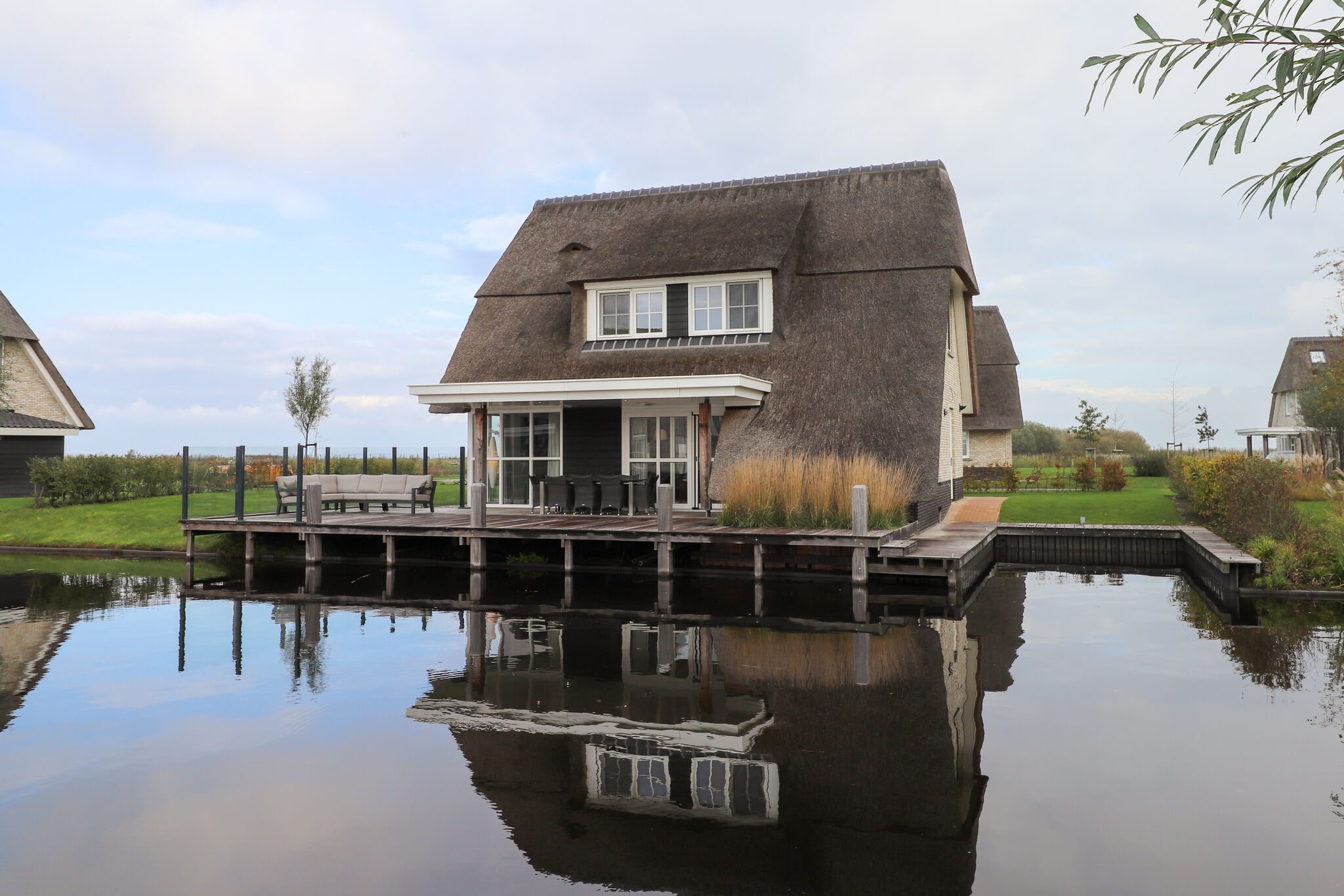 Thatched villa with lounge set, right at the water