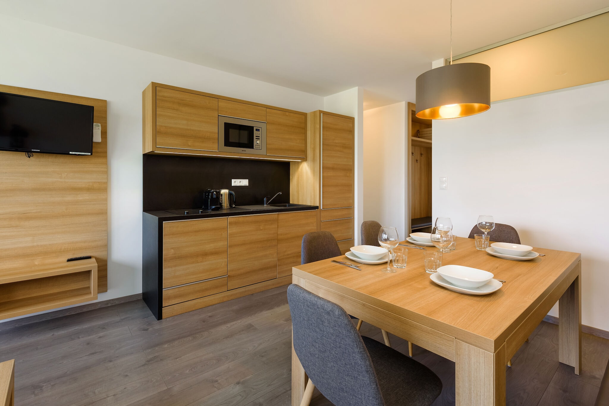 On the 1st floor: (Living room(double sofa bed, TV, balcony), open kitchen(dining table, electric kettle, cooker(2 ring stoves), coffee machine(cups), combination microwave, dishwasher, fridge-freezer), bedroom(double bed), bedroom(double bed), bathroom(shower, washbasin, toilet))\n\nparking, swimming pool(shared with other guests, natural swimming pond)