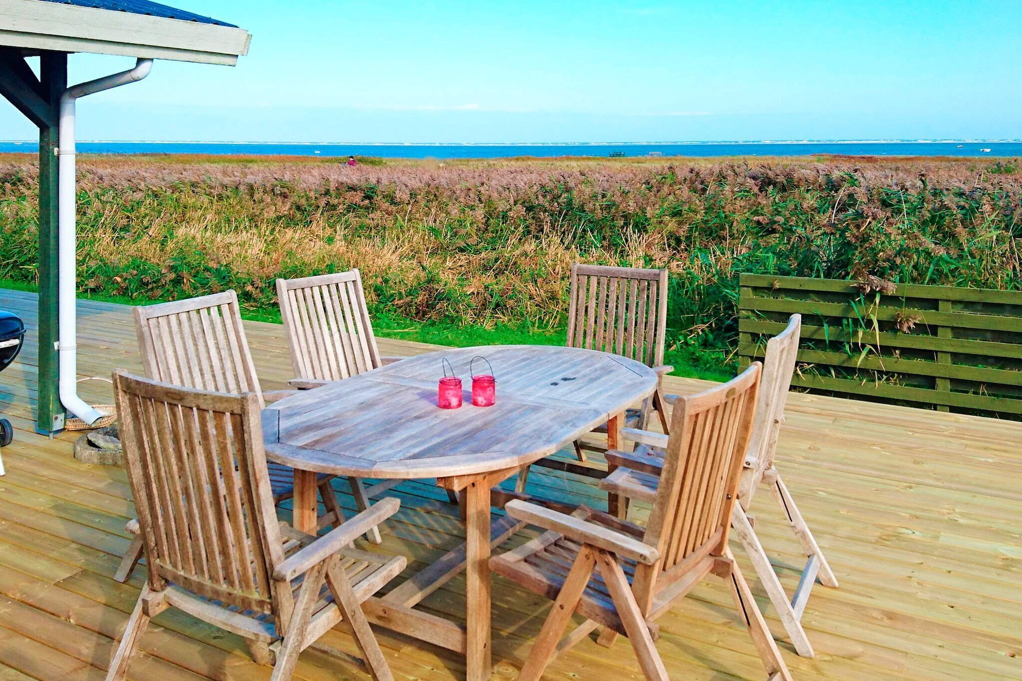 Wake up to sweeping sea views in this charming holiday home at Als Odde, just steps away from the sea. Located in a tranquil setting with a generous natural plot of 1100 m², it’s a perfect retreat for families or friends who want both peace and proximity to the coast. With three terraces—partially covered—you can enjoy your morning coffee with the sunrise, a leisurely lunch in the open air, or cozy evenings grilling under the stars. Inside, the bright living room with large windows frames panoramic views of the sea, creating a beautiful backdrop whether you’re relaxing by the wood-burning stove or gathering around the dining table. The open kitchen is fully equipped with everything you need, including a dishwasher, making mealtimes easy and social. The house has three bedrooms—two with double beds and one with twin beds—providing comfortable spaces for up to six guests. The property blends modern comforts with its natural surroundings. Energy-friendly solutions, TV with both Danish and German channels, and a charming interior ensure a comfortable stay. Just 50 meters from the coast, with excellent fishing opportunities nearby and a restaurant within a short drive, this seaside retreat invites you to slow down, recharge, and savor the beauty of the Danish coastline.