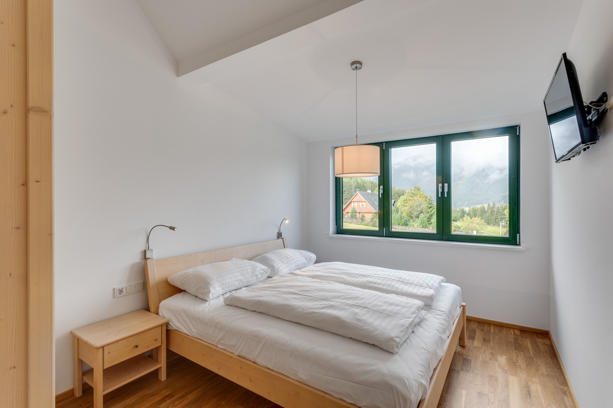 On the 2nd floor: (open kitchen(cooker, oven, microwave, dishwasher, fridge-freezer), Living/diningroom(TV, dining table, seating area, balcony), bedroom(double bed), bedroom(double bed), bathroom(shower, washbasin, toilet), bathroom(shower, washbasin, toilet))\n\nhigh chair