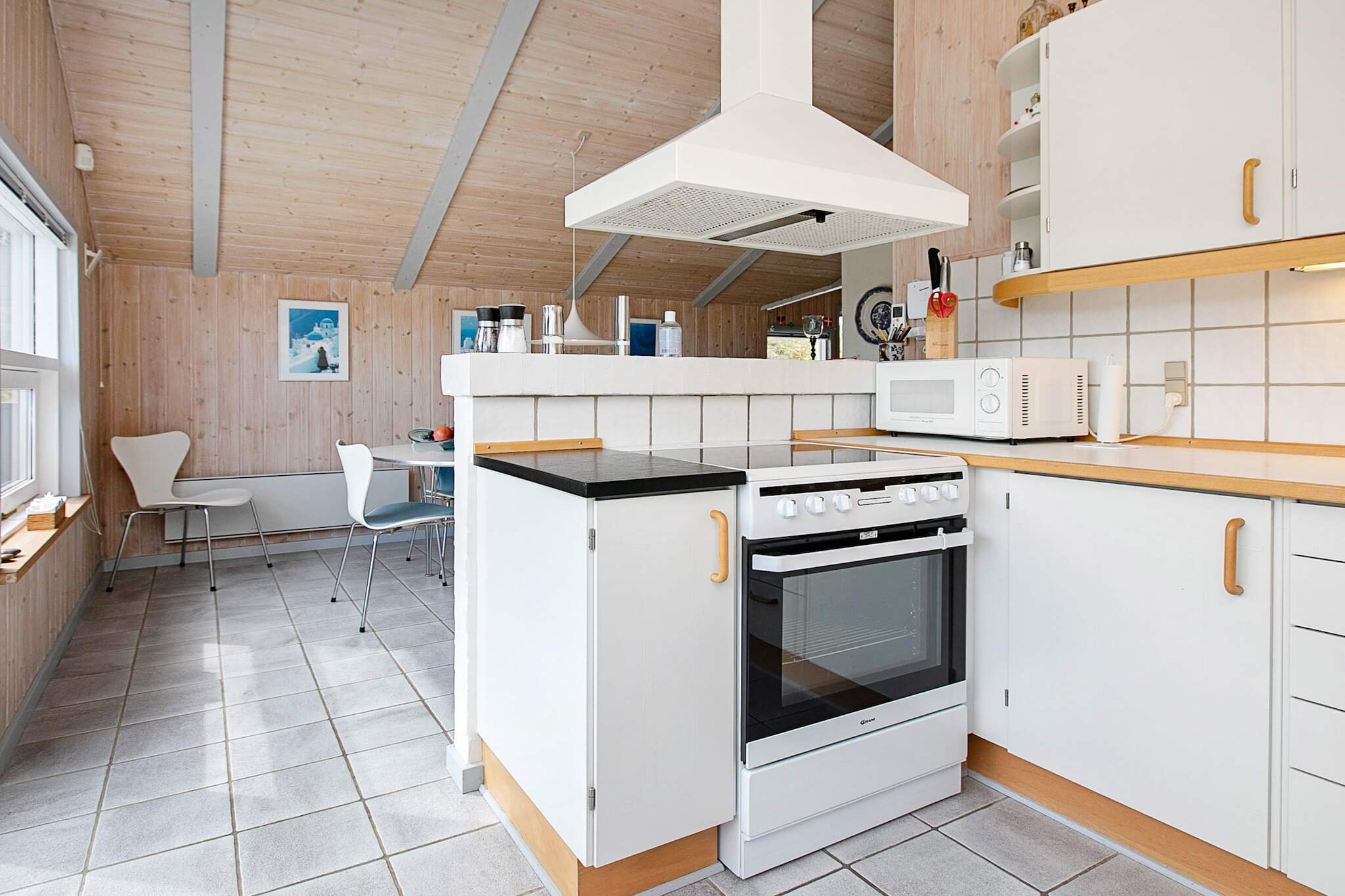 Annex: (2x single folding bed)\n\nopen kitchen(cooker(electric), hood, coffee machine, microwave, dishwasher, fridge(+ freezer)), Living/bed room(TV(cable, german television channels, danish TV channels (DR1 and TV2)), DVD player, radio, CD player, stereo unit), bedroom(double bed), bedroom(double bed), bedroom(2x bunk bed), bathroom(floor heating)(bathtub or shower, washbasin, toilet, washing machine), sauna(indoor, heated, 6 persons), heating(electric), terrace, terrace(roofed), BBQ, table football, air to air heatpump
