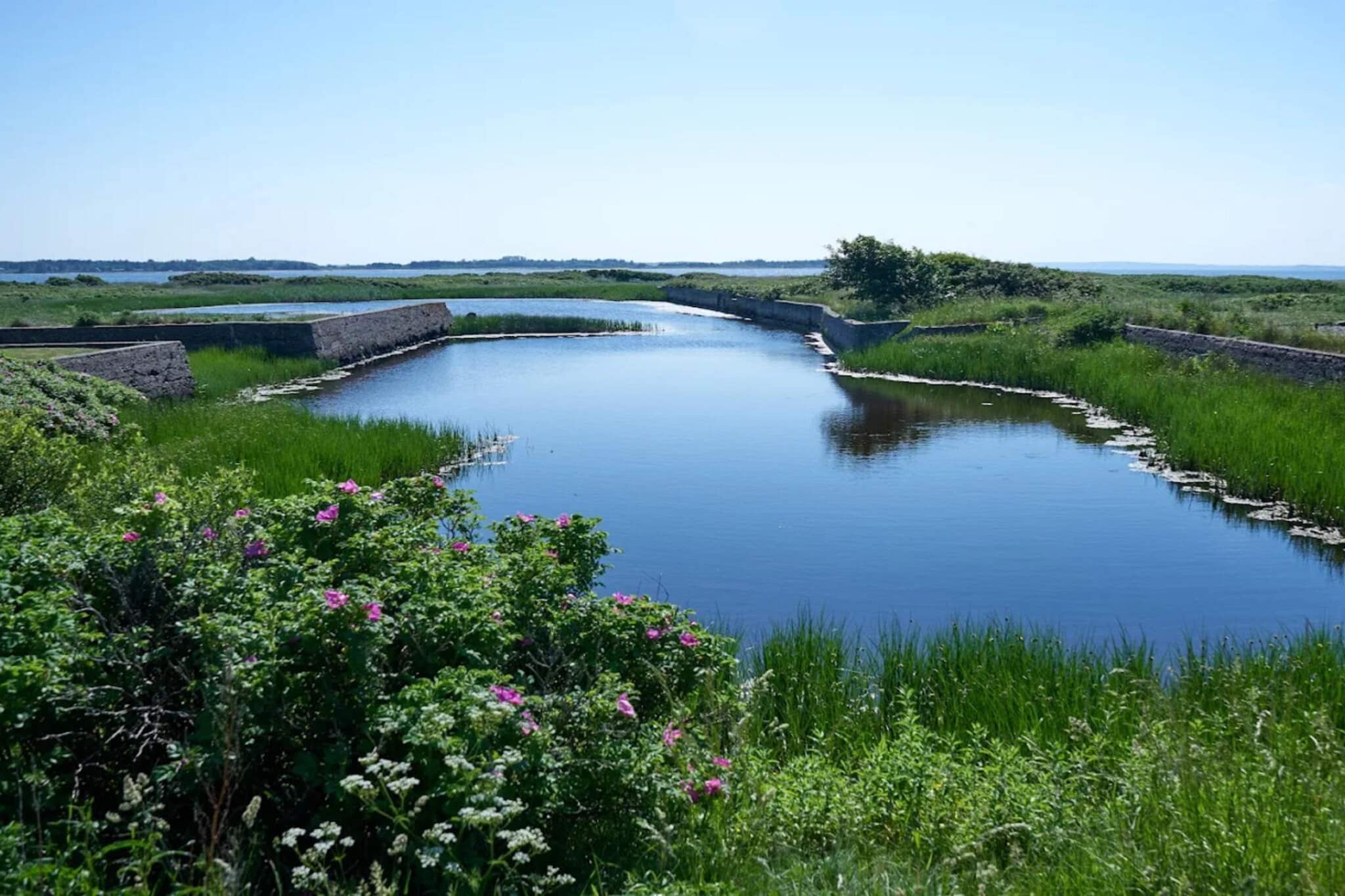 open kitchen(cooker(electric), hood, coffee machine, microwave, dishwasher, fridge(+ freezer)), Living/bed room(double folding bed, TV(danish TV channels (DR1 and TV2)), DVD player, radio, high chair), bedroom(double bed, cot), bedroom(double bed), bedroom(2x single bed), bathroom(floor heating)(bathtub or shower, washbasin, toilet, washing machine), terrace, BBQ