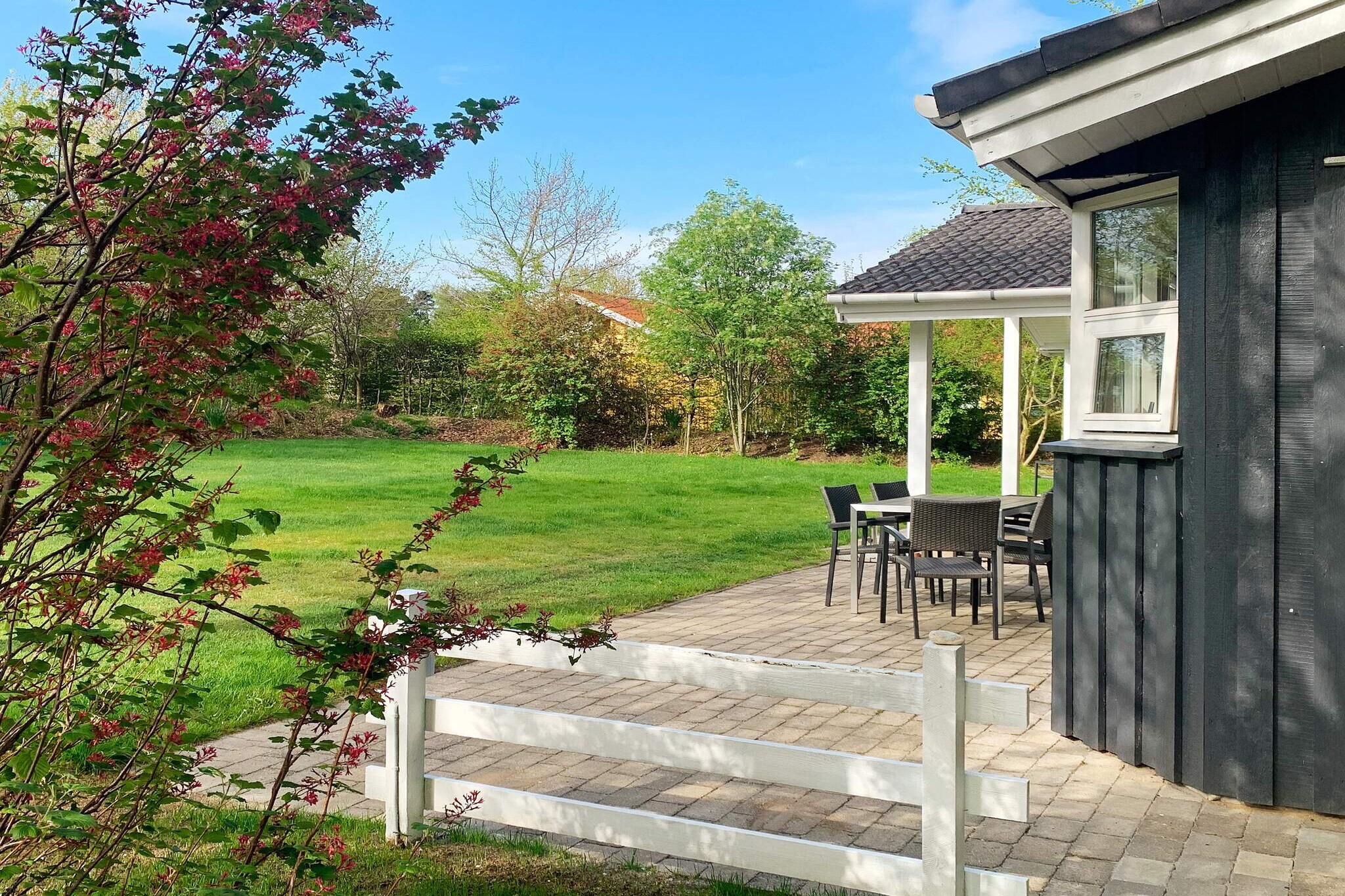 This lovely vacation home with a hot tub and sauna is located in a peaceful vacation home area close to the beach, shopping, and the charming coastal town of Gilleleje. The house features a bright and inviting living room with a wood-burning stove and air-to-air heat pump, ensuring comfort and coziness all year round. Entertainment is covered with TV (including Chromecast and DR channels), cable TV, and wireless internet. The open kitchen is well-equipped with ceramic hobs, microwave, extractor hood, and fridge/freezer—perfect for holiday meals. The house has three bedrooms, two of which have extra-long double beds (210 cm), making them suitable for tall guests. There is a baby cot and a high chair in the house. There are two bathrooms with showers and underfloor heating, one of which offers a relaxing wellness experience with both a spa bath and sauna. A washing machine and dryer complete the comfort. The property is 1,240 m² and equipped with everything you need for a great vacation in the open air: a large lawn, a pavilion with garden furniture and barbecue, an outdoor fireplace, a campfire site, and a swing, sandbox, and play tower for the little ones. In addition, there is both an open and covered terrace with good garden furniture – the perfect setting for cozy moments in all kinds of weather. Not available for rental to youth groups.A refundable deposit might be charged closer to your check-in date. The security deposit ensures a smooth stay and covers any additional services or consumption charges.This deposit covers utilities consumed during your stay and any additional services that may be taken.The final amount will be adjusted based on actual meter readings, actual usage of extra services, and any remaining balance will be refunded within 21 days after checkout.This deposit simply acts as a prepayment for charges that  you would anyways pay for, ensuring a seamless stay and check-out experience.