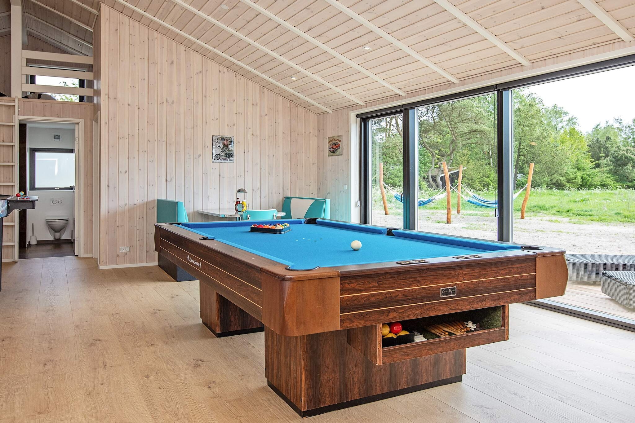 High-quality holiday home with hot tub, sauna and wilderness bath, perfectly located just 400 metres from the most beautiful beach in Lyngså. The holiday home is tastefully decorated, and if you are looking for something out of the ordinary, this modern and well-appointed holiday home is worth a closer look. There are fun activities for the whole family, plenty of space and high ceilings, where the whole family can enjoy themselves and spend some quality time together. The style is modern and functional with three large, bright bedrooms with good beds and closet space, a loft with a good staircase and mattresses for cosy days. Welcoming, open entrance hall with washing machine and tumble dryer. There are two bathrooms with shower cubicles and underfloor heating, one of which has a spa bath for cosy moments. The heart of the holiday home is a large, open living room with good acoustics, connected to the well-equipped kitchen. There is room for everyone to get together and enjoy cooking, meals, games, a good film or whatever else takes your fancy. The room has several windows, allowing the fascinating North Jutland light to flood in, and on warm days you can open up to the terrace. There are lovely terraces around the house, including a wilderness bath, plenty of shelter, shade and the opportunity to move around with the sun. There is also a patio heater. The lawn offers plenty of space for games and ball games. There is a trampoline (use at your own risk/insurance) and 4 hammocks. The holiday home is equipped with a good activity room, which can be used in the evening, on grey days or if you are holidaying in the colder months, guaranteeing many hours of fun. There is a games machine with over 300 games built in, as well as a PlayStation. The holiday home is just 400 metres from Lyngså Beach, a lovely beach with no traffic and shallow water. There is an electric car charger. No youth groups or tradesmen's groups.A refundable deposit might be charged closer to your check-in date. The security deposit ensures a smooth stay and covers any additional services or consumption charges.This deposit covers utilities consumed during your stay and any additional services that may be taken.The final amount will be adjusted based on actual meter readings, actual usage of extra services, and any remaining balance will be refunded within 21 days after checkout.This deposit simply acts as a prepayment for charges that  you would anyways pay for, ensuring a seamless stay and check-out experience.