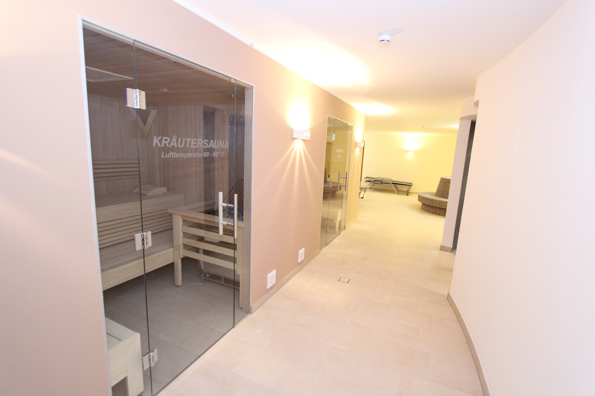 On the 1st floor: (hallway, Living room(TV(digital), DVD player, stereo unit), open kitchen(electric kettle, coffee machine(filter), oven, microwave, dishwasher, fridge-freezer), bedroom(double bed), Bedroom with bathroom(double bed, bunk bed, shower, washbasin, toilet), bathroom(shower, washbasin, toilet))\n\nsanitary facility(tumble dryer(shared with other guests), washing machine(shared with other guests)), relaxation area(shared with other guests)(shower, massage shower, sauna, toilet), garage, ski boot heaters, balcony, heating(floor heating), garden furniture, lift