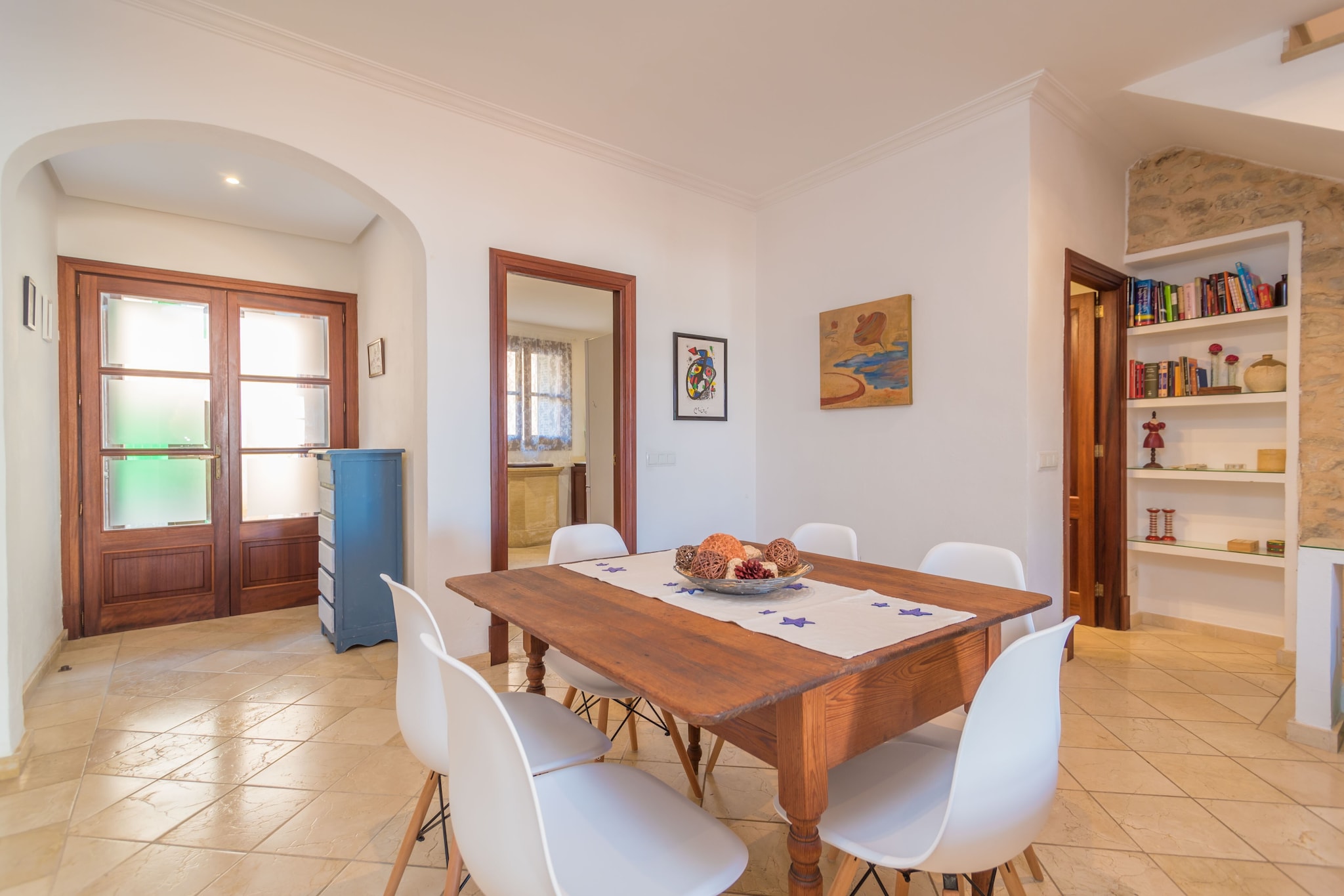 This beautiful house is located in the centre of one of the most emblematic villages in the island. Mallorcan traditions and roots are really preserved here. In order to enjoy the good weather, the house features a spacious terrace furnished with a large garden table and chairs where you can not only enjoy long evenings with your loved ones but also delicious barbecued meats and vegetables. The house is in the town centre and there are direct neighbours.
This is a great house which still preserves the Mallorcan personality of the building but, at the same time, with all modern comforts so that you can feel at home. From the terrace you enter the spacious living-dining room equipped with a large and cosy sofa, satellite TV and air-conditioning for the hottest days. The kitchen is independent and you will find it fully equipped with a ceramic hob, oven microwave and a little table with 4 chairs to cook in good company. You will also find the old well in the kitchen, a traditional architectonic element that has been kept (although with no use nowadays). There is also a laundry area in the house with a washing machine, an iron and an ironing board. A little toilet with basin and WC completes the ground floor. The original stairs lead to the 1st floor where there are two bedrooms. One has a double bed, a walk-in closet and it is air-conditioned. The other one has two twin beds and a closet. A shower bathroom completes this floor. Going upstairs once more where we find the last bedroom with a double bed, a fan and a beautiful en-suite shower bathroom. This floor also offers a terrace where our guests can admire the views over the Pla de Mallorca. If you are travelling with a baby we can prepare a cot and a high chair on request. This large house also presents a little playing room on the basement.
Montuiri is a wonderful village located over a little hill and surrounded by wind mills, the perfect example of the traditional and rural Mallorca. Our guests will find peace and calm in here. All basic services for an independent stay can be found in the village, where you can also acquire fresh local products, good Mallorcan wines and other high quality products like sea salt, honey or olive oil. Its location in center of the island is perfect to reach several points and get to know the different faces of Mallorca: the cosmopolitan city of Palma to the south; the beauty of nature in the Tramuntana mountain range to the west; the beautiful beaches of Cales de Mallorca to the east, and the marvellous medieval villages of Pollensa and Alcudia to the north. Consult the advertiser for possible charges. Pets are not allowed. The holding of events is forbidden. There are parking space for 1 cars in the garage.
Distances
Beach: 28.3 km - Platja de Sa Ràpita
Airport: 22 km - Son Sant Joan, Palma
Golf course: 21.1 km - Golf Son Gual, Palma
Town: 0.001 km - Montuiri
Train station: 10.5 km - Estació Sineu
Bus stop: 0.240 km - C/de Palma, Montuiri
Ferry: 32.5 km - Port de Palma
Hospital: 23.6 km - Hospital de Manacor
Tourist license: ETV/11968Single Rental Registry: ESFCTU0000070290000201700000000000000000000ETV/119689Homerti - Central de Reservas CR/33