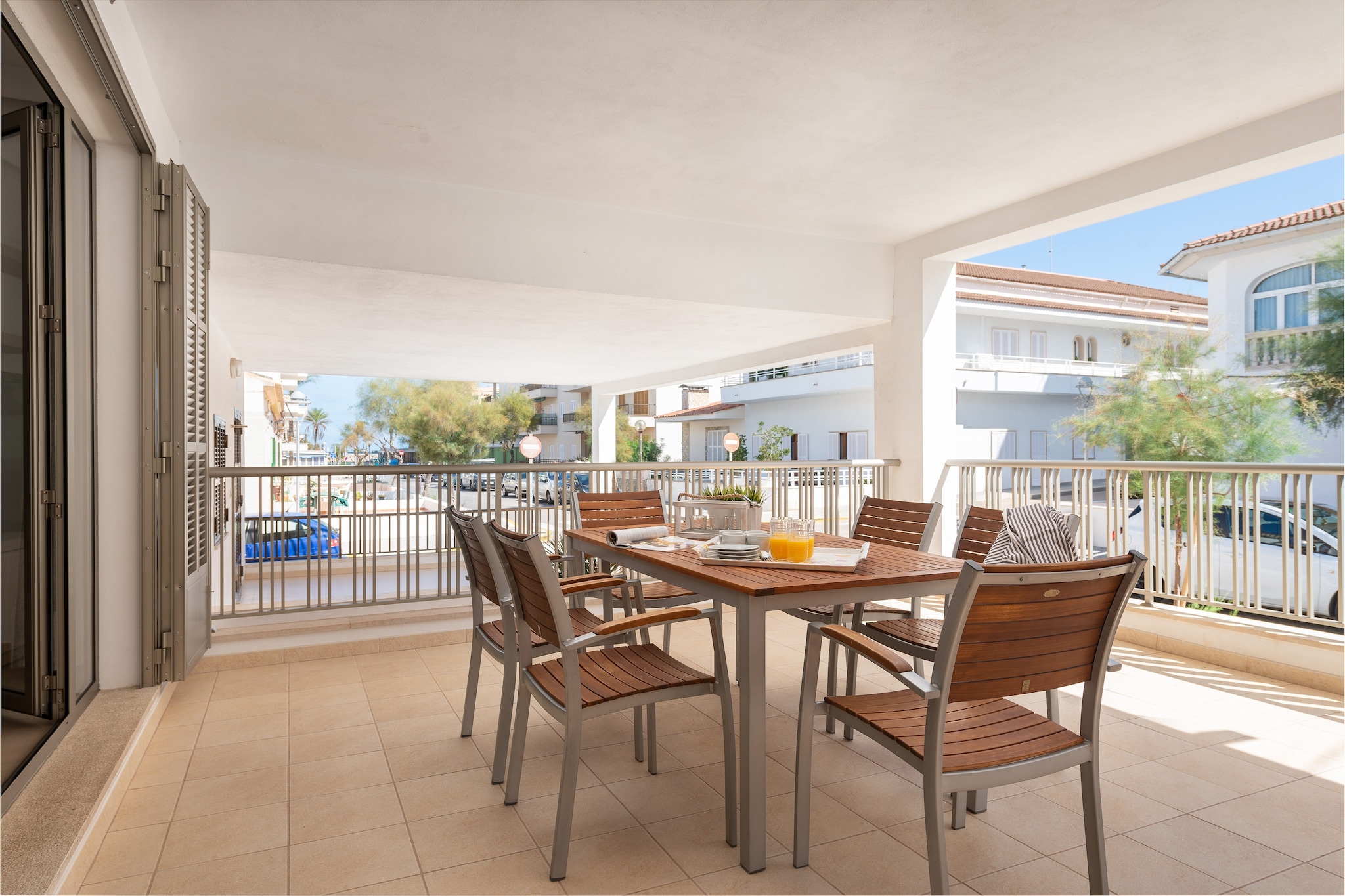 From the street, a few steps up lead to the spacious private terrace that is wonderfully equipped to enjoy your family meals. The comfortable table with chairs will allow you to enjoy the good weather on the island as well as admire the sea at the end of the street. The apartment is located on the ground floor of a building with only one more neighbour, in a residential area of Can Picafort. 

From the same terrace, you can enter the apartment that presents a modern and comfy style. The living room offers a TV with satellite channels and AC. The modern kitchen-diner is fully equipped and has a ceramic hob. From here you will have access to the laundry area outside which is equipped with a washing machine, iron and ironing board. In the apartment there are two bedrooms, both with double bed and wardrobe and one of them also with AC and en suite bathroom with shower. There is also another bathroom with a shower for the rest of the house. Finally, we can prepare a cot and a high chair in case you are travelling with your baby. 

Can Picafort is a family destination on the island of Mallorca that has a fabulous beach of fine sand and transparent waters. Of course, it offers all the necessary services for an independent stay such as bars, restaurants, shops and supermarkets. Not far away, you find the paradisaical beaches of Ses Casetes dels Capellans or Playa de Muro. Another option is to visit the old city of Alcudia or Pollensa or spend a different day playing golf in front of the sea in the course of Alcanada. Consult the advertiser for possible charges. Pets are not allowed. The holding of events is forbidden. 
Distances
Beach: 0.240 km - Can Picafort
Airport: 65.3 km - Son Sant Joan
Golf course: 15.9 km - Club de Golf Alcanada
Town: 0.230 km - Can Picafort
Train station: 15.7 km - Sa Pobla
Bus stop: 0.550 km - Can Picafort
Ferry: 13.3 km - Port d'Alcúdia
Hospital: 27.7 km - Hospital Comarcal d'Inca
Tourist license: ETVPL/15223Single Rental Registry: ESFCTU00000701100104284800000000000000000ETVPL/152231There's a mandatory tourist tax in Balearic Islands, called Ecotasa. All guests, except people under 16 years, have to pay this tax. The amount varies between 0.55€/night and guest during the low season and 2.2€/night and guest during  the high season .The tax is reduced by half from the 9th day for your stay. Homerti - Central de Reservas CR/33