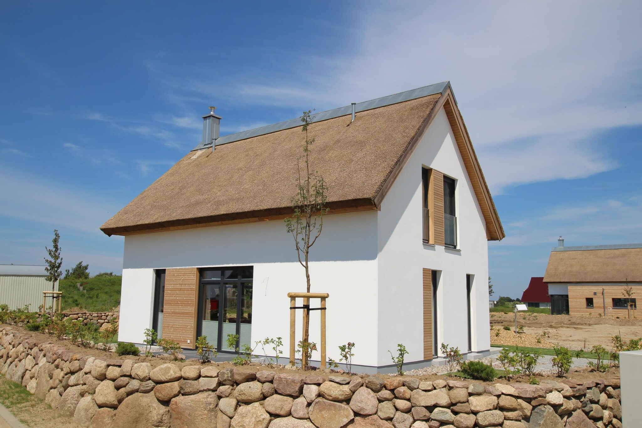 Ground floor: (bathroom(bath tub, shower, sauna, toilet))\n\nOn the 1st floor: (bedroom(double bed, TV(satellite)), bedroom(double bed, TV(satellite)), bathroom(shower, toilet), bathroom(shower, toilet))\n\nopen kitchen(dining table, hob(4 ring stoves, ceramic), electric kettle, toaster, coffee machine, oven, dishwasher, fridge-freezer), Living/diningroom(double sofa bed, TV(satellite), fireplace, radio, CD player, heating), storage, washing machine, parking