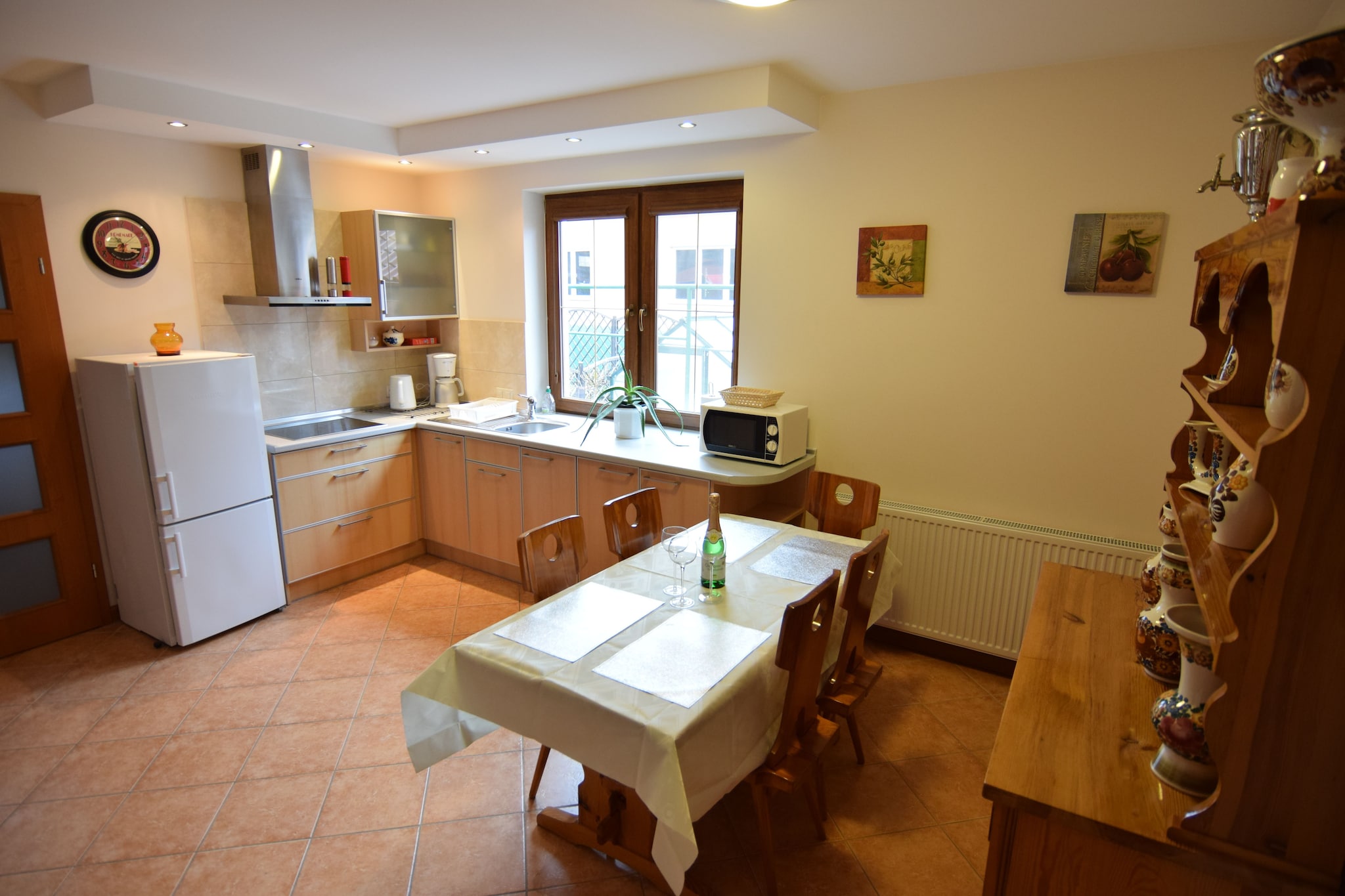 Ground floor: (Kitchen(dining table(5 persons), hob(4 ring stoves, induction), electric kettle, hood, coffee machine, microwave, fridge-freezer), bathroom(shower, washbasin, toilet, washing machine))\n\nOn the 1st floor: (bedroom(single sofa bed, double bed, TV(flatscreen)), bedroom(2x single bed), bathroom(shower, washbasin, toilet))\n\nInternet access, Lawn, heating(central), garden(shared with the owner , fenced, 4500 m2), garden furniture, BBQ(charcoal), parking, sand pit, slide, outdoor fireplace, Garden shed, Swing set
