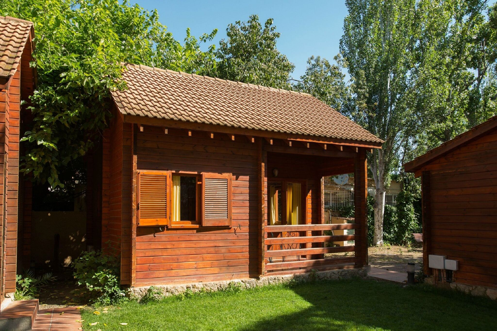 Wooden bungalow with a covered terrace, 1 km. from beach