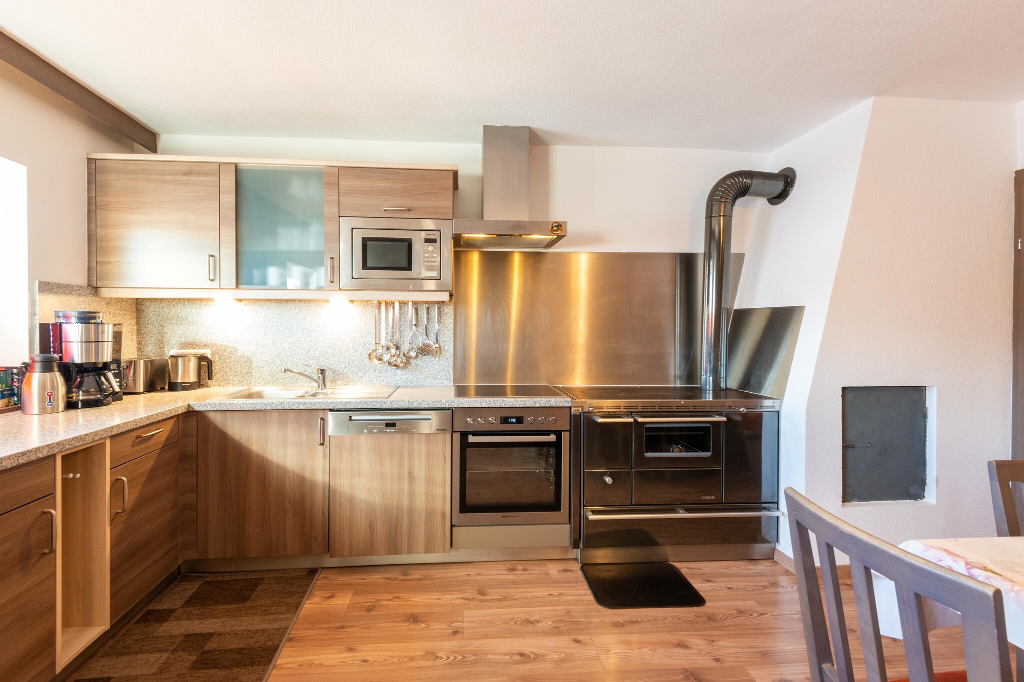 Ground floor: (Entrance, Kitchen(hob(4 ring stoves, ceramic), electric kettle, toaster, hood, coffee machine, oven, microwave, dishwasher, fridge-freezer), Living/diningroom(TV(satellite), dining table, seating area), bathroom(shower), bathroom(shower, shower), toilet)\n\nOn the 1st floor: (bedroom(double bed), bedroom(double bed), bedroom(double bed), bedroom(single bed, double bed), bedroom(single bed, double bed), bedroom(double bed), toilet, relaxation area(sauna))\n\nski storage, carport, sauna(paid), ski boot heaters, heating(central), terrace, parking, high chair, baby crib(free)