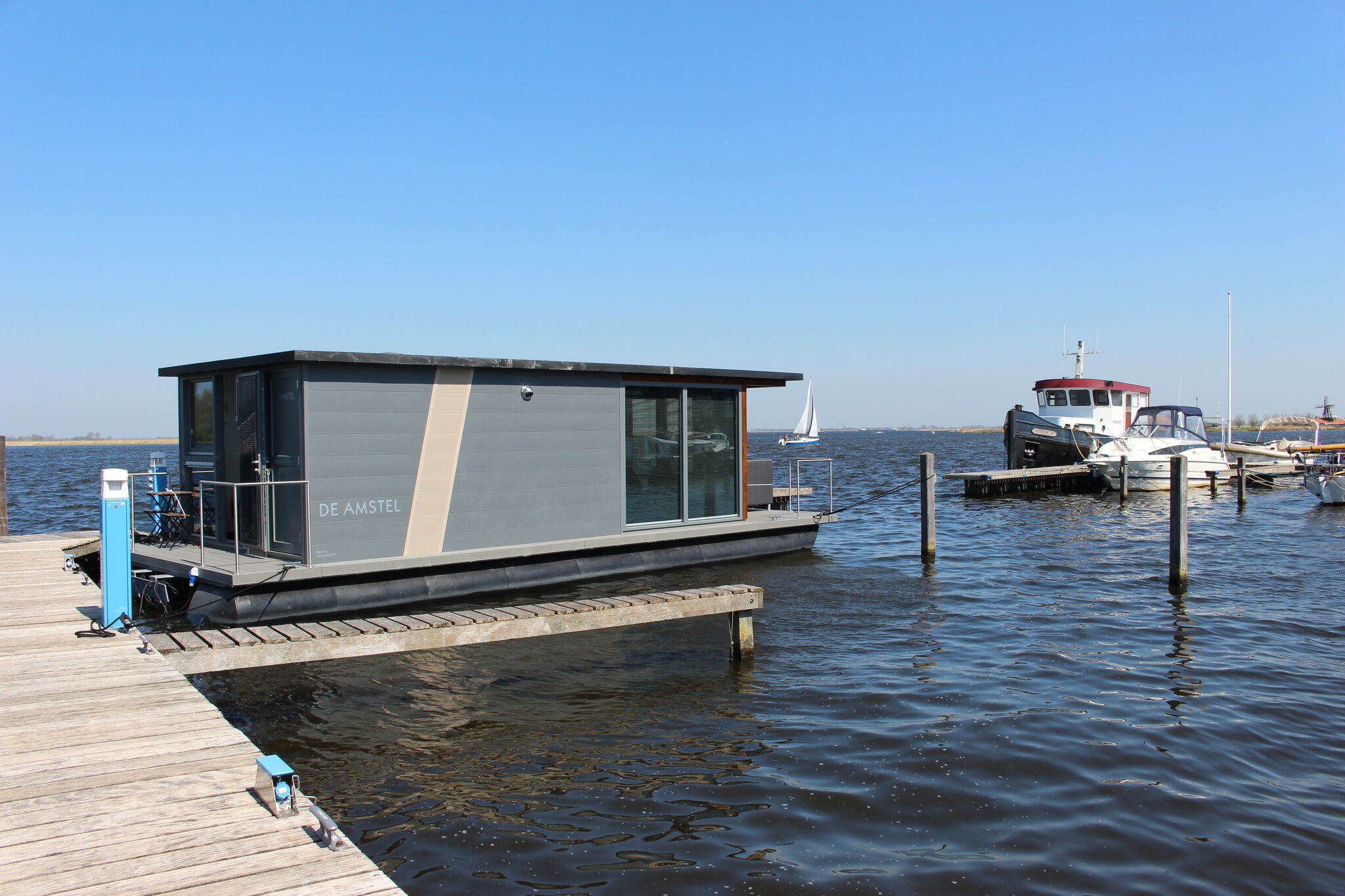 Modern houseboat with air conditioning located in marina