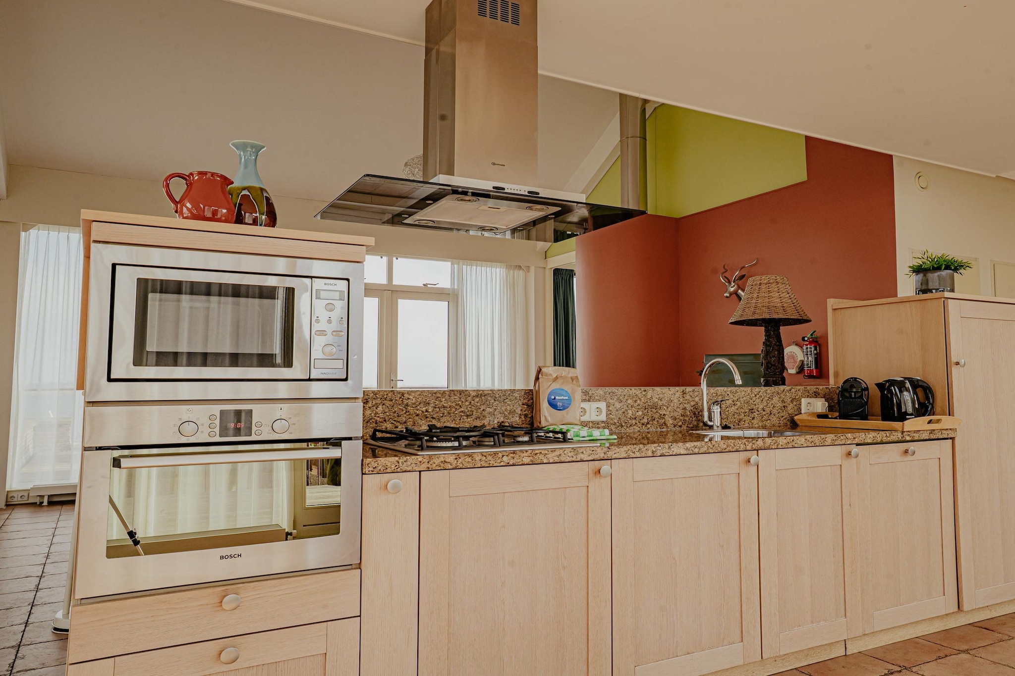 On the 1st floor: (open kitchen(electric kettle, cooker(4 ring stoves, gas), coffee machine(cups), oven, microwave, dishwasher), Living/diningroom(double sofa bed, fireplace, seating area), Bedroom with bathroom(single bed, single bed, bath tub, shower, washbasin, toilet, bidet))\n\nheating(central), roof terrace, garden furniture, parking