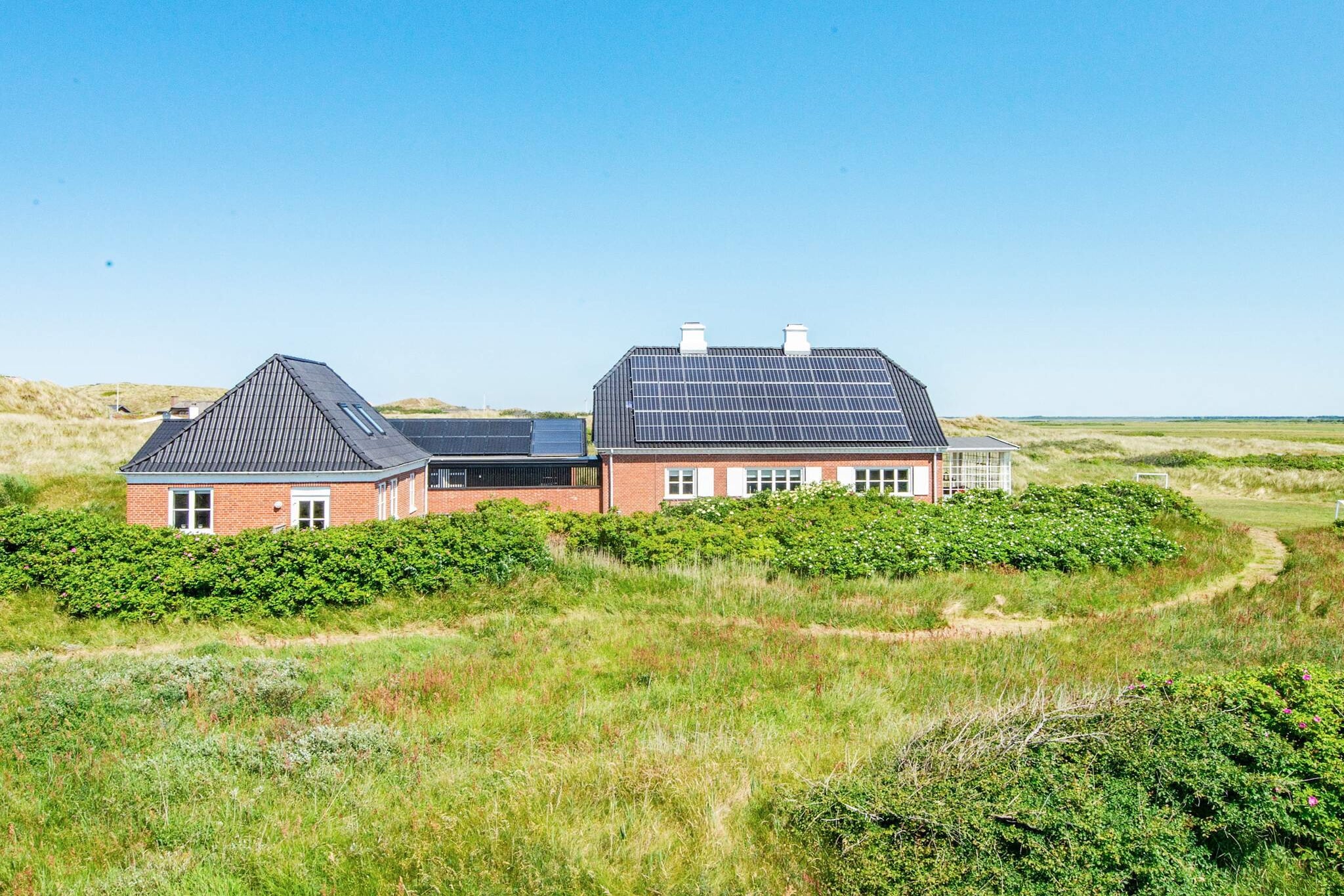 Annex: (double bed)\n\nInternet Access DSL, Sitting room(2x single folding bed), Kitchen(cooker(electric), hood, coffee machine, microwave, dishwasher, fridge, freezer(60-99L)), Living/bed room(TV(german television channels, danish TV channels (DR1 and TV2)), DVD player), bedroom(double bed), bedroom(double bed), bedroom(2x single bed, double bed), bedroom(3x double bed), bedroom(double bed), bathroom(floor heating)(tumble dryer, bathtub or shower, washbasin, toilet, washing machine), bathroom(floor heating)(bathtub or shower, washbasin, toilet), bathroom(floor heating)(bathtub or shower, washbasin, toilet), bathroom(bathtub or shower, washbasin, toilet), conservatory, Bubble bath(outside, 6 persons), sauna(indoor, heated, 4 persons), terrace, BBQ, swimming pool(indoor, 200 m2), play equipment, table football, football goal, billiards, fish cleaning table, geothermal energy, solar energy, air to water heatpump