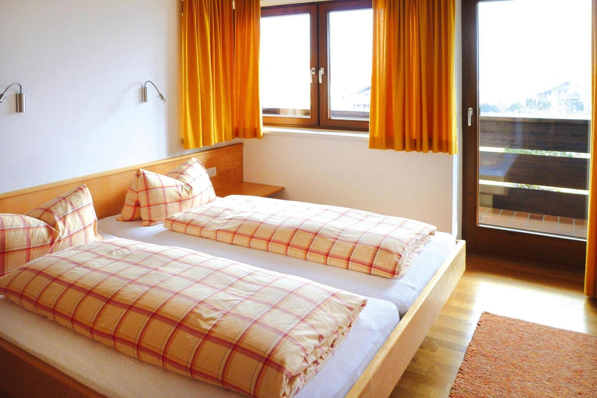 On the 1st floor: (Entrance, open kitchen(hob(4 ring stoves, electric), electric kettle, coffee machine, oven, microwave, dishwasher, fridge), Living/bed room(double sofa bed(180 x 200 cm), TV(satellite), baby crib(free)))\n\nAttic: (Bedroom with bathroom(double bed, TV(satellite), shower, toilet), Bedroom with bathroom(double bed, TV(satellite), bath tub, toilet))\n\nSitting room, seating area, bar, grill, washing machine, balcony, heating, terrace(roofed), garden furniture, sun loungers, parking