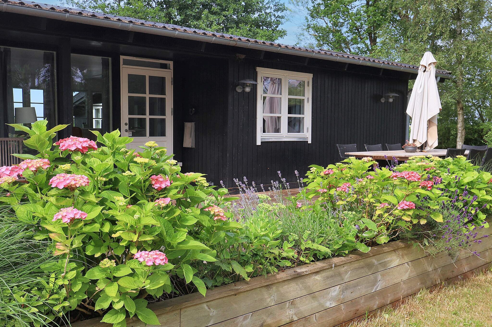 This classic black and white cottage by Kindvig Enge exudes charm and cozy atmosphere. The two annexes on the plot, RÃ¸verhytten and Svalero, are built in the same style and give you extra space and opportunities. Vibekrogen is an obvious choice for both for several couples of friends or the family with children, also with teenagers, who can each get their own little house. The kitchen is fully equipped with i.a. minifood processes. The terraces on both sides of the house ensure that you can always find a place in the sun or shade. From here there are also beautiful views of the beaches and their rich bird life. With approx. 125 meters from the house you can take a dip from the jetty or put your kayak or small boat in the water and fish, just enjoy the shore from the water side or go to the nearest port and get an ice cream. Not for rent to youth groups.