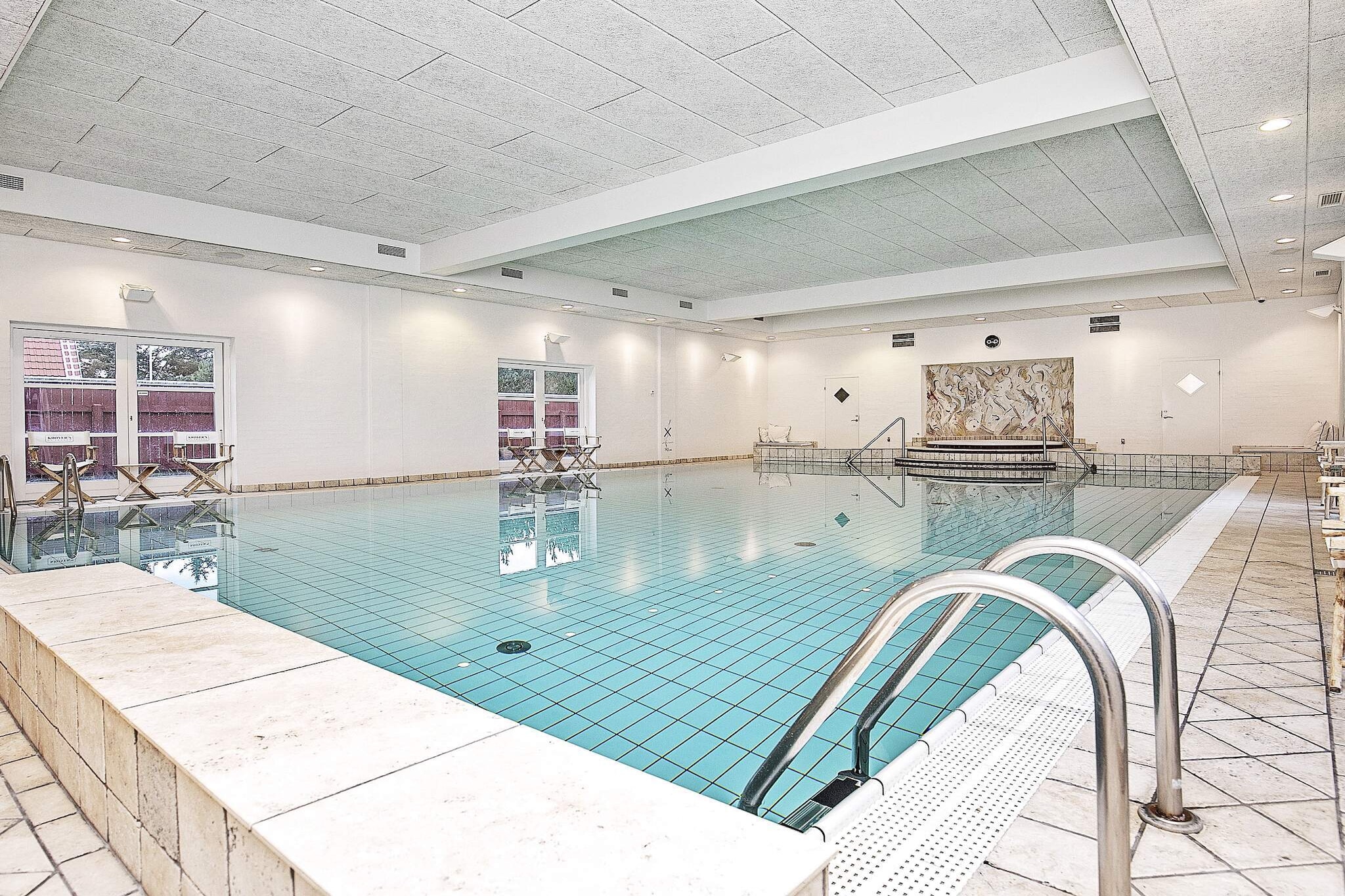 Holiday apartment located at Feriecenter Krøyer's Gl. Skagen with access to a shared hot tub, sauna, and indoor swimming pool. This tasteful holiday apartment is furnished with interiors from Philippe Starck and B&amp;O and is ideal for adults. At Krøyer's exclusive holiday home, you will experience the perfect atmosphere of Gl. Skagen. In the charming Skagen yellow houses, you will be staying just a few hundred meters from the sea, beach, and dunes, with everything within easy reach: restaurants, art museums, galleries, and fantastic shopping opportunities. The apartment is located on the ground floor with a large kitchen/living room, which is the heart of the home, with all modern amenities, a lovely dining area, and a cozy living room accompanied by a beautiful fireplace and comfortable lounge furniture, where you can enjoy board games or watch a good movie on TV.The tasteful interior design of the vacation homes consists of a kitchen from Gaggenau and furniture from Casa Marc Italy. The kitchen/living room has direct access to the terrace. The apartment's bathroom is equipped with a shower, toilet, and sink. Bright bedroom furnished with a double bed (2 x 90 x 200 cm beds pushed together as a double bed). The fireplace in the living room creates the right atmosphere when darkness falls. Treat your better half to a dip in the swimming pool and hot tub. Krøyer's wellness building with hot tub, sauna, and indoor pool is just a few meters from the front door. The light is absolutely fantastic at the top of Denmark. Skagen's varied landscape is characterized by the sea and miles of white beaches. Take a trip to Denmark's northernmost point, Grenen, where the two seas, Skagerrak and Kattegat, meet, or visit one of the many other attractions in the area. Flagbakken is a paradise for birdwatchers. Not available for rental to youth groups.A refundable deposit might be charged closer to your check-in date. The security deposit ensures a smooth stay and covers any additional services or consumption charges.This deposit covers utilities consumed during your stay and any additional services that may be taken.The final amount will be adjusted based on actual meter readings, actual usage of extra services, and any remaining balance will be refunded within 21 days after checkout.This deposit simply acts as a prepayment for charges that  you would anyways pay for, ensuring a seamless stay and check-out experience.