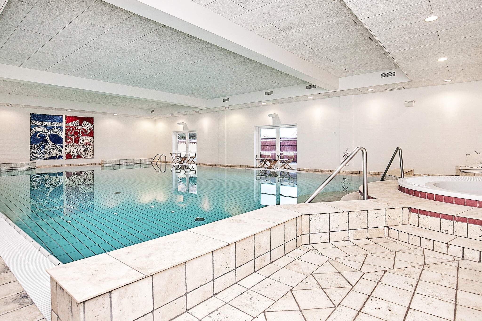 Holiday apartment located at Feriecenter Krøyer's Gl. Skagen with access to a shared hot tub, sauna, and indoor swimming pool. This tasteful holiday apartment is furnished with interiors from Philippe Starck and B&O and is ideal for adults. At Krøyer's exclusive holiday home, you will experience the perfect atmosphere of Gl. Skagen. In the charming Skagen yellow houses, you will be staying just a few hundred meters from the sea, beach, and dunes, with everything within easy reach: restaurants, art museums, galleries, and fantastic shopping opportunities. The apartment is located on the ground floor with a large kitchen/living room, which is the heart of the home, with all modern amenities, a lovely dining area, and a cozy living room accompanied by a beautiful fireplace and comfortable lounge furniture, where you can enjoy board games or watch a good movie on TV.The tasteful interior design of the vacation homes consists of a kitchen from Gaggenau and furniture from Casa Marc Italy. The kitchen/living room has direct access to the terrace. The apartment's bathroom is equipped with a shower, toilet, and sink. Bright bedroom furnished with a double bed (2 x 90 x 200 cm beds pushed together as a double bed). The fireplace in the living room creates the right atmosphere when darkness falls. Treat your better half to a dip in the swimming pool and hot tub. Krøyer's wellness building with hot tub, sauna, and indoor pool is just a few meters from the front door. The light is absolutely fantastic at the top of Denmark. Skagen's varied landscape is characterized by the sea and miles of white beaches. Take a trip to Denmark's northernmost point, Grenen, where the two seas, Skagerrak and Kattegat, meet, or visit one of the many other attractions in the area. Flagbakken is a paradise for birdwatchers. Not available for rental to youth groups.A refundable deposit might be charged closer to your check-in date. The security deposit ensures a smooth stay and covers any additional services or consumption charges.This deposit covers utilities consumed during your stay and any additional services that may be taken.The final amount will be adjusted based on actual meter readings, actual usage of extra services, and any remaining balance will be refunded within 21 days after checkout.This deposit simply acts as a prepayment for charges that  you would anyways pay for, ensuring a seamless stay and check-out experience.