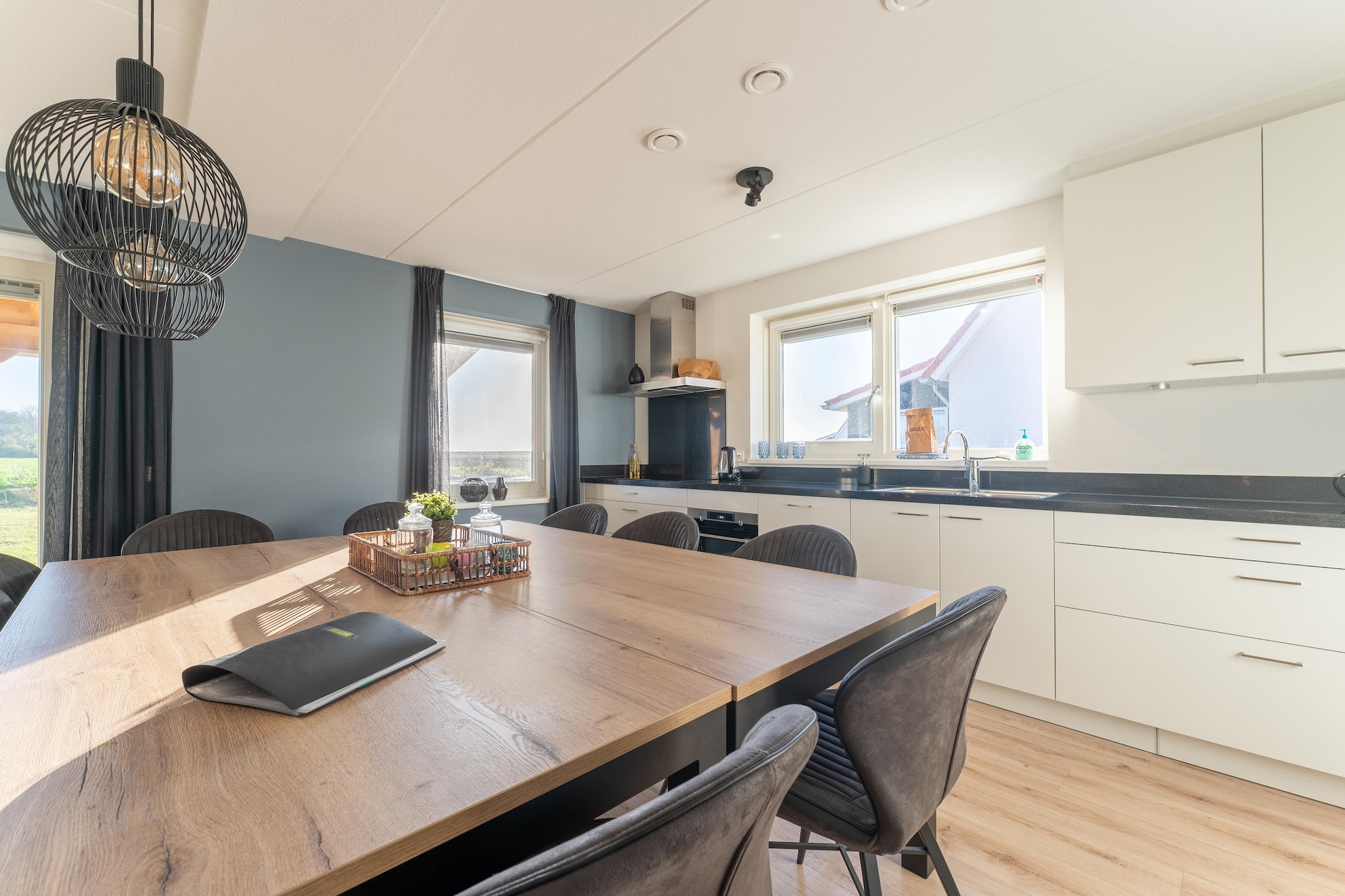 Ground floor: (hallway(toilet), open kitchen(dining table, hob(5 ring stoves, electric), cooker, hood, coffee machine, combination microwave, dishwasher, fridge-freezer), Living/diningroom(TV, seating area), Bedroom with bathroom(double bed, shower), Bedroom with bathroom(double bed, shower))\n\nOn the 1st floor: (bedroom(double bed or 2 single beds), bedroom(double bed or 2 single beds), bedroom(double bed or 2 single beds), Bedroom with bathroom(single bed, single bed), bathroom(shower), toilet)\n\nterrace, garden, BBQ, parking, lounge set