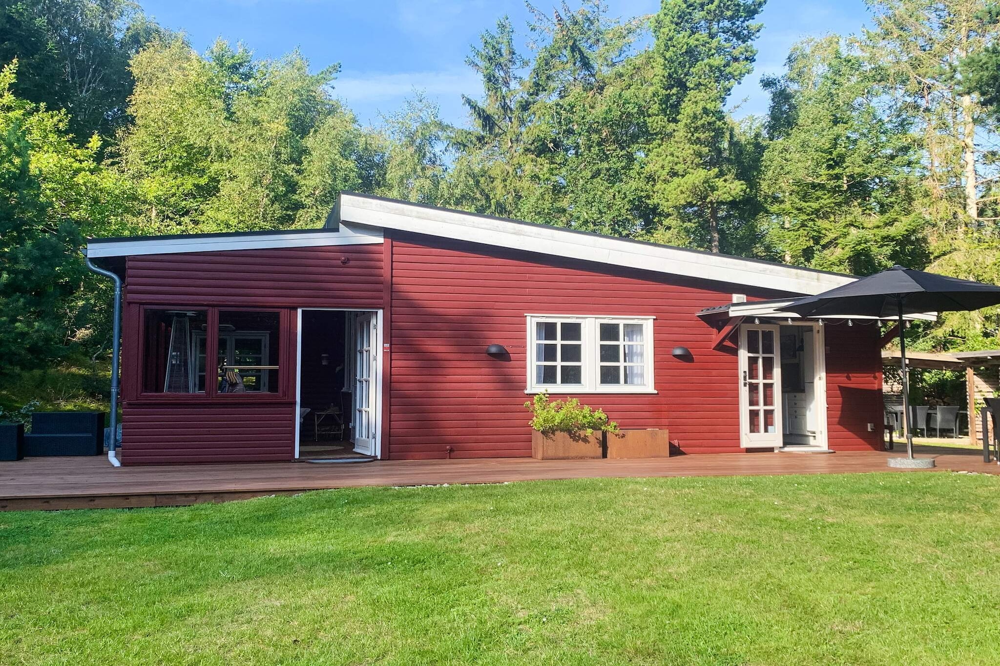 This inviting holiday home is set in the coastal town of Rageleje, just a short 275-meter stroll from the beach and the refreshing waters of the North Coast of Zealand. Surrounded by a lovely natural plot, it offers plenty of space to relax and enjoy the outdoors, making it a wonderful choice for families looking to combine comfort with a traditional seaside atmosphere. You are welcomed through a bright glass-enclosed veranda, where a table football game sets the tone for fun evenings together. The heart of the home is a spacious open kitchen and living area, equipped with modern conveniences including a ceramic cooktop, extractor hood, fridge freezer, and dishwasher. The cozy living room provides a perfect spot to unwind with a TV and WiFi after a day at the beach. The house features three bedrooms: two with comfortable double beds and a third with a bunk bed for two, making it ideal for families or small groups. A bathroom with a shower, washing machine, and dryer ensures practical comfort throughout your stay. The home is heated by an eco-friendly air-to-air heat pump and a wood-burning stove, adding a warm and inviting touch. Outside, there are several terraces for sunbathing, dining, or simply enjoying the fresh coastal air. The spacious garden even includes a trampoline, perfect for kids, though use is at your own risk. With its prime location in one of Zealand’s most beloved beach destinations and its charming blend of comfort and tradition, this holiday home offers a memorable escape. Please note: This property is not rented to youth groups, ensuring a peaceful, family-friendly environment.A refundable deposit might be charged closer to your check-in date. The security deposit ensures a smooth stay and covers any additional services or consumption charges.This deposit covers utilities consumed during your stay and any additional services that may be taken.The final amount will be adjusted based on actual meter readings, actual usage of extra services, and any remaining balance will be refunded within 21 days after checkout.This deposit simply acts as a prepayment for charges that  you would anyways pay for, ensuring a seamless stay and check-out experience.