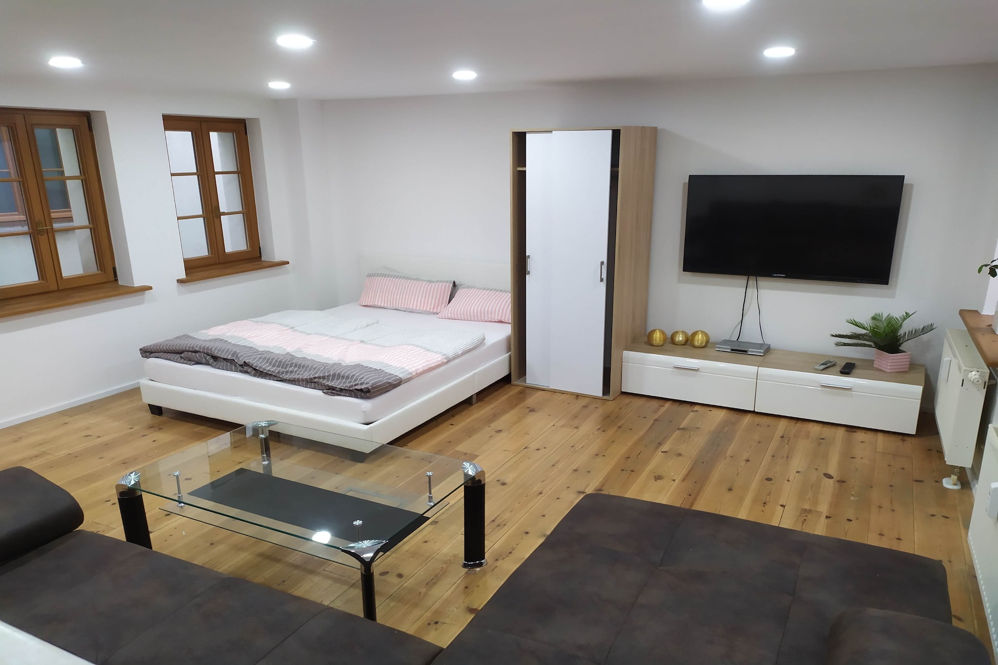 Ground floor: (open kitchen(electric kettle, cooker, coffee machine, oven, microwave, fridge), Living/bed room(single sofa bed, double bed, TV, seating area), bathroom(bathtub or shower, washbasin, toilet))