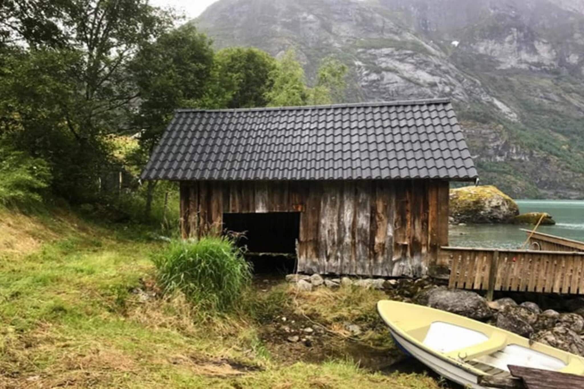 Cozy holiday home with panoramic views of the lake Oppstrynsvatnet. Boathouse, private pier, and rowing boat. The holiday home is of an older vintage and was modernized in 1985. In the living room there is a wood burning stove, firewood is included in the rent. TV with NRK 1, 2 and 3. One bedroom has folding single beds. Parking 20 m from the holiday home. The holiday home is located on a natural plot with a shoreline towards Oppstrynsvannet. 25 meters to the nearest neighbor. Water and electricity are included in the rent. Great hiking terrain, the nearest hiking trail is 200m from the holiday home. The homeowner also has two mountain cabins for guests to use, the trip there takes 2-3 hours walk through medium demanding terrain. The homeowner can participate as a tour guide up to the cabins, please arrange this with the homeowner upon arrival if wanted. 14 km to ski lift/alpine, cross-country, and light trails. 40 km to ski trail in the summer. Experience Loen Skylift with a commuter train from fjord to mountain in 5 minutes and Hoven view restaurant 1100 masl. Via Ferrata/airy suspension bridge 750 masl., in Loen. Uppstrynsvannet has good fishing for char and trout of 200-500 grams, in addition to the occasional salmon. Fishing equipment can be stored in the boathouse. 20 m to the swimming opportunities and the mooring where you find the rowing boat. Between 1/10 -30/4 boat use is subject to weather conditions.