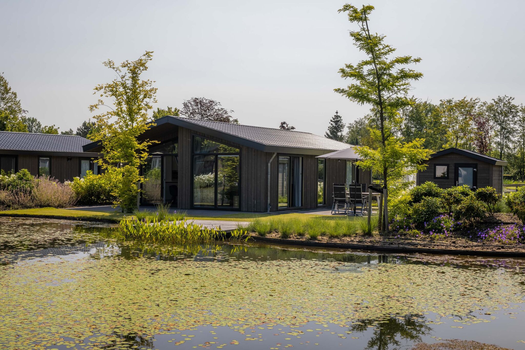 Modern chalet on the pond in a holiday park