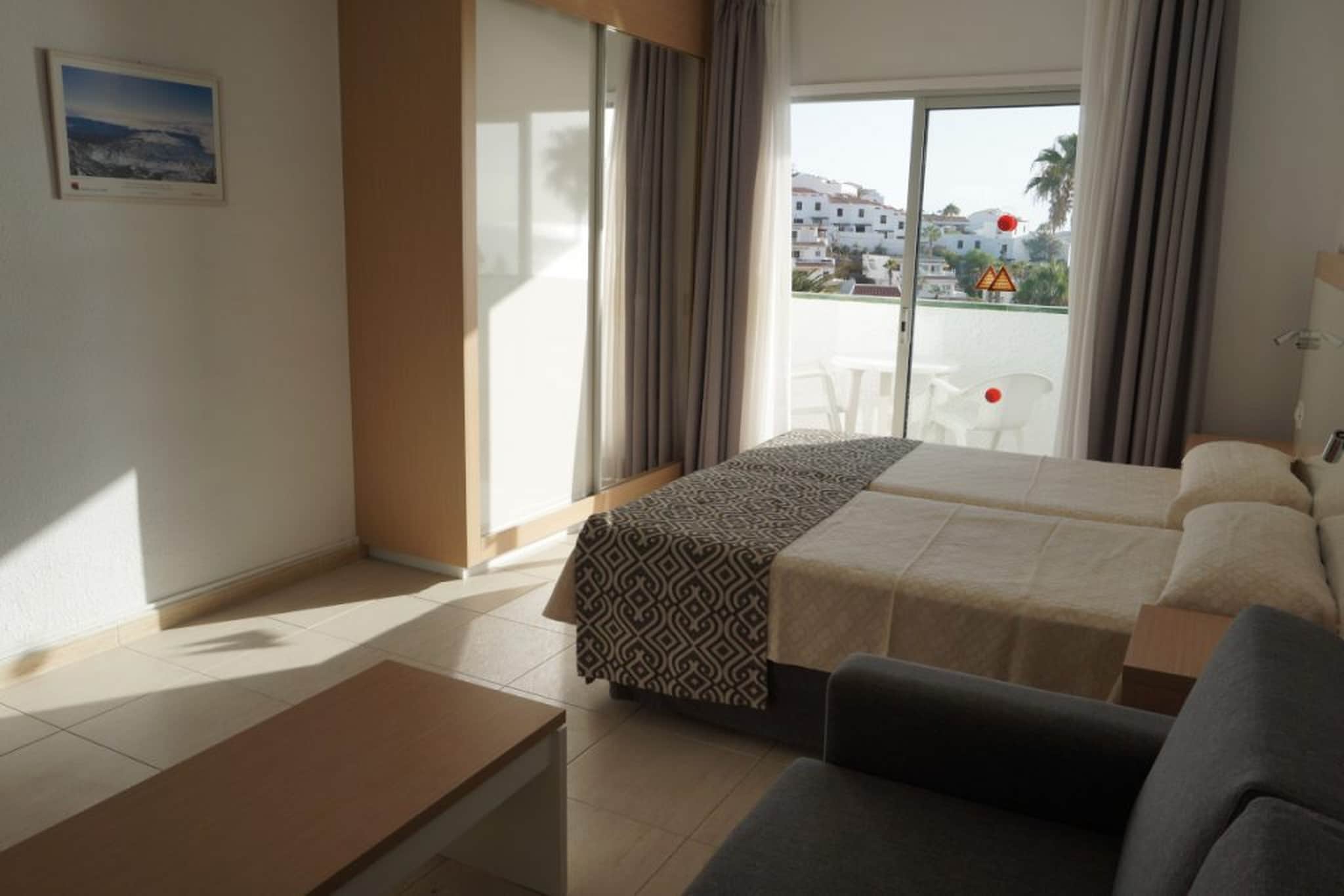 This comfortable apartment on Tenerife is blessed with a pleasant location, close to the sea. It is ideal for sun holidays with family or friends.
Spend your days in the sun or visit to nearby places such as Puerto de Santiago and the picturesque Tamaimo. You can hit a ball at Buenavista Golf and Paisaje Lunar El Teno Alto forms a beautiful decor for Insta-worthy photos. Other interesting sights on Tenerife are: the El Teide volcano, water park Siam Park and Loro Parque zoo.
The apartment offers access to a communal swimming pool. The simply furnished kitchen offers you the opportunity to prepare delicious dishes and you can end the evening with a snack and a drink on the balcony or terrace.
About Belvilla
When you stay in a Belvilla home, you can rest assured of a unique holiday home in ideal surroundings at an attractive price. The portfolio of accommodations consists of more than 40,000-holiday homes in 20 European countries. Interested in a weekend getaway, a summer or winter sports holiday or simply a short break? Do you prefer the coast, the countryside or the mountains? Whatever your preference, there is a Belvilla home to meet your needs, from a cosy gîte for two to a castle big enough for the entire family, from an apartment in the heart of Rome to a cabin in the middle of nowhere, from a simple tree house to a luxury dream villa and from close to home to the other side of Europe.
A Belvilla home gives you the freedom to enjoy breakfast in your pyjamas or continue a good conversation into the morning hours without having to worry about the bar's closing time. Prepare gourmet meals with fresh local ingredients in your own kitchen and take advantage of having your own swimming pool to do as many cannonballs as you want! In other words, you can enjoy complete privacy in your home away from home.