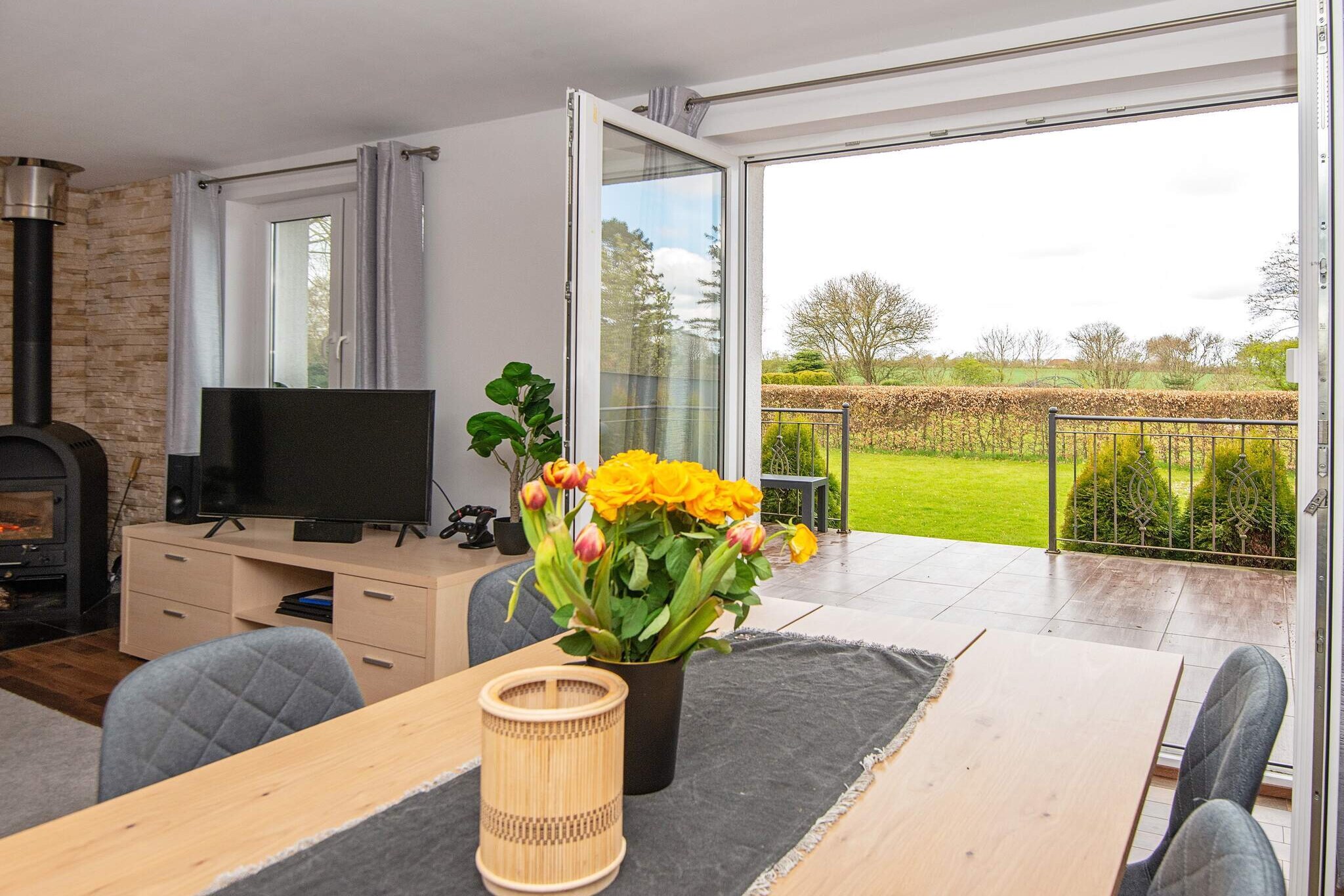 Kitchen(cooker(2 ring stoves), hood, coffee machine, microwave, dishwasher, fridge-freezer), Living/bed room(TV(german television channels, danish TV channels (DR1 and TV2)), stereo unit, high chair), bedroom(double bed), bedroom(double bed), bedroom(double bed), bathroom(washbasin, hip bath, shower, toilet), carport, terrace, garden, garden furniture