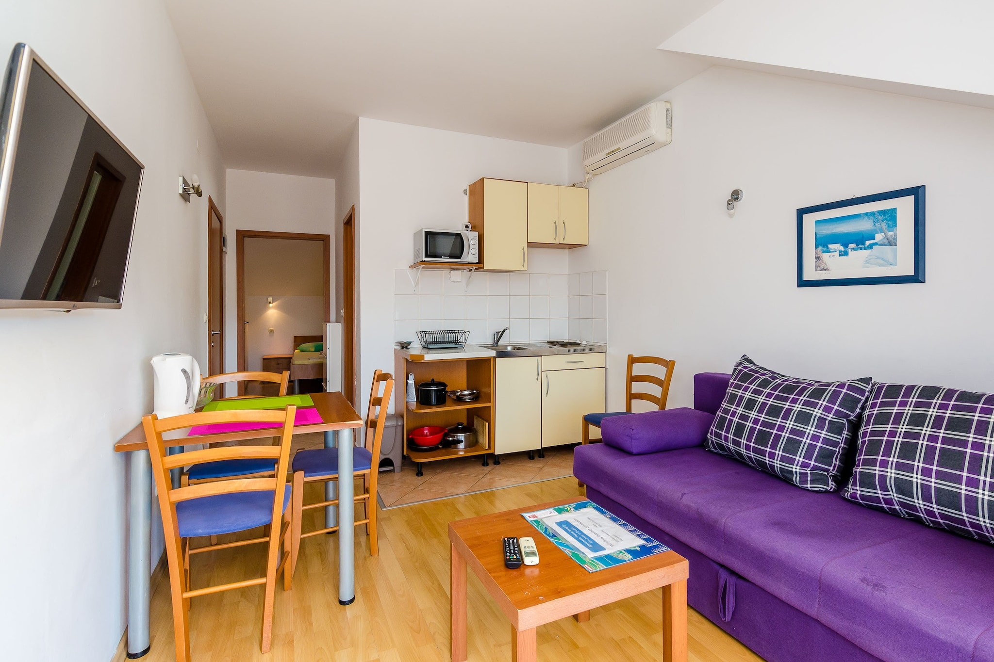 On the 1st floor: (Living room, Kitchen(hob, microwave), Living/bed room(single sofa bed), bedroom(small double bed), bathroom)\n\nTV, stove, electric kettle, fridge, shower, balcony, air conditioning, parking lot(public)