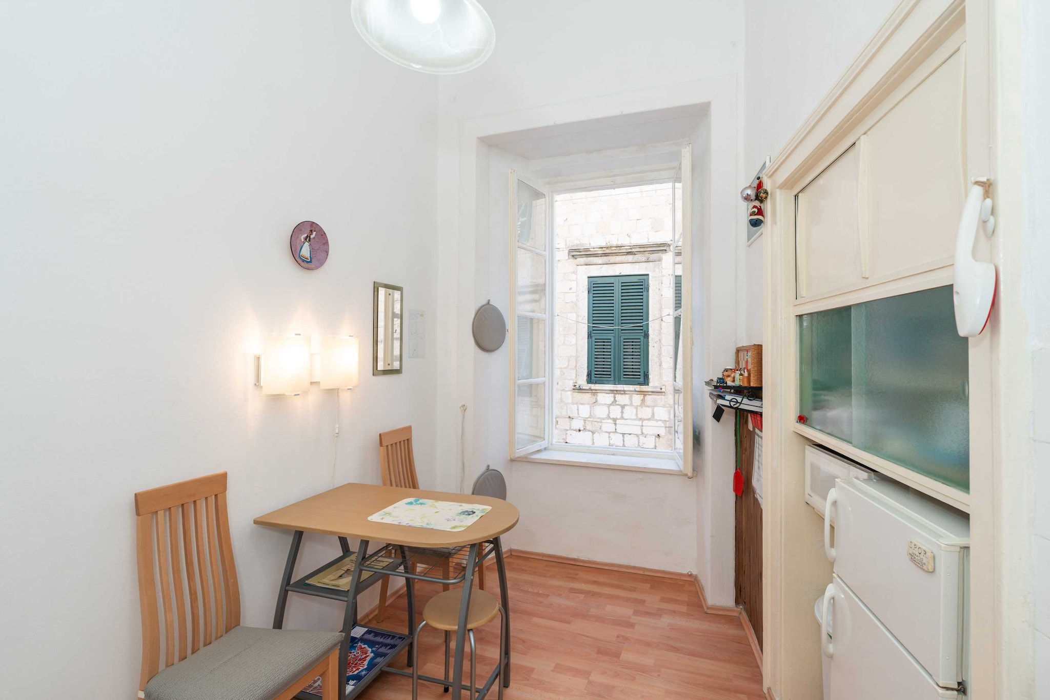 Two Stars Downtown Apartment offers  accommodation in the heart of Dubrovnik, inside the City Walls. 
Please be advised that children cannot be accommodated at the property.

This apartment can comfortably accommodate up to two people.
It features free Wi-Fi, air conditioning. Kitchen is well equipped and comes with dining table. One bedroom comes with double bed. Private bathroom is fitted with bathtub, hairdryer and washing machine. Dryer and ironing facilities will also be at guests' disposal.

The apartment is situated inside the city walls, just a stone's throw away from the Old Town's central street Stradun, so everything you may need is in 300 meters range.   
The apartment is located just 500 meters from the nearest beach, with many more of them in surrounding area and beautiful island Lokrum just a 15 minutes boat ride away. There is an open-air green market and other shops within walking distance, as well as many bars, restaurants, cafes, a bakery, pharmacy, banks and ATM's. Famous night club Revelin, located inside the old fort, is just 400 meters away.
There is no need for public transit while You're staying here, but if you want to see other parts of the town, for example peaceful Lapad Bay, you can be there in a 10 minute drive. 
Taxi and bus station are 3 minute walk from the property.

Dubrovnik bus station and ferry port, connecting the mainland with various Dalmatian islands, are 10 minutes ride from the apartment, while Dubrovnik Airport is 21 km away.