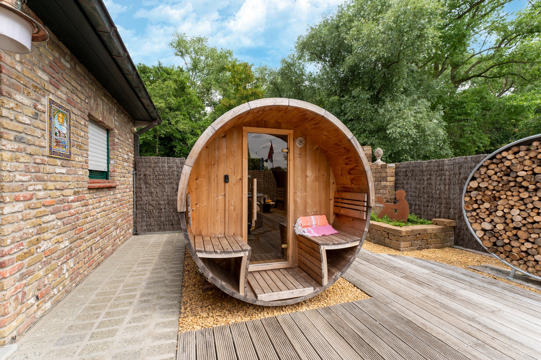 Ground floor: (Kitchen(hob(ceramic), electric kettle, espresso machine, combination microwave, dishwasher, fridge, Hand blender), Living/diningroom(TV, dining table, fireplace, seating area, high chair), bedroom(double bed, cot), bathroom(bath tub, shower, washbasin, washbasin), toilet(toilet), pantry(fridge))\n\nOn the 1st floor: (bedroom(double bed), bedroom(double bed, double trundle bed), bedroom(double bed), bathroom(bathtub with shower, washbasin), toilet(toilet), recreation room(seating area, bar, darts))\n\ncoffee machine, bath tub, hot tub, shower, shower, sauna, terrace, garden, bicycle storage, garden furniture, sun loungers, BBQ, parking, pond, deckchairs, parasol, ironing board, lounge set, outdoor fireplace