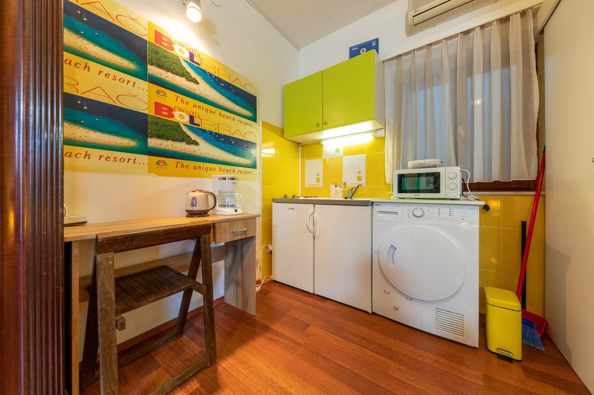 Ground floor: (Living room, Kitchenette, Living/bed room(single bed, small double bed), bathroom(shower))\n\ntoilet, TV, dining table, stove, electric kettle, toaster, microwave, fridge, freezer, washing machine, air conditioning, parking lot(public), ironing board, iron, hairdryer