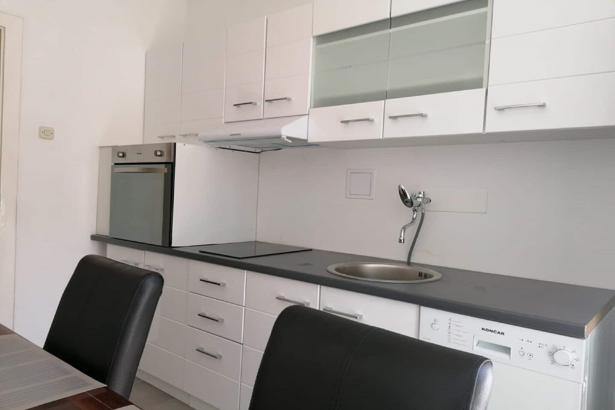 On the 2nd floor: (Living room(TV, seating area), Kitchen(dining table, stove, electric kettle, toaster, hood, coffee machine, oven, dishwasher, fridge, freezer), Living/bed room(single sofa bed), bedroom(double bed), bathroom(bath tub), toilet)\n\ncot, washing machine, balcony, air conditioning, ironing board, iron, hairdryer