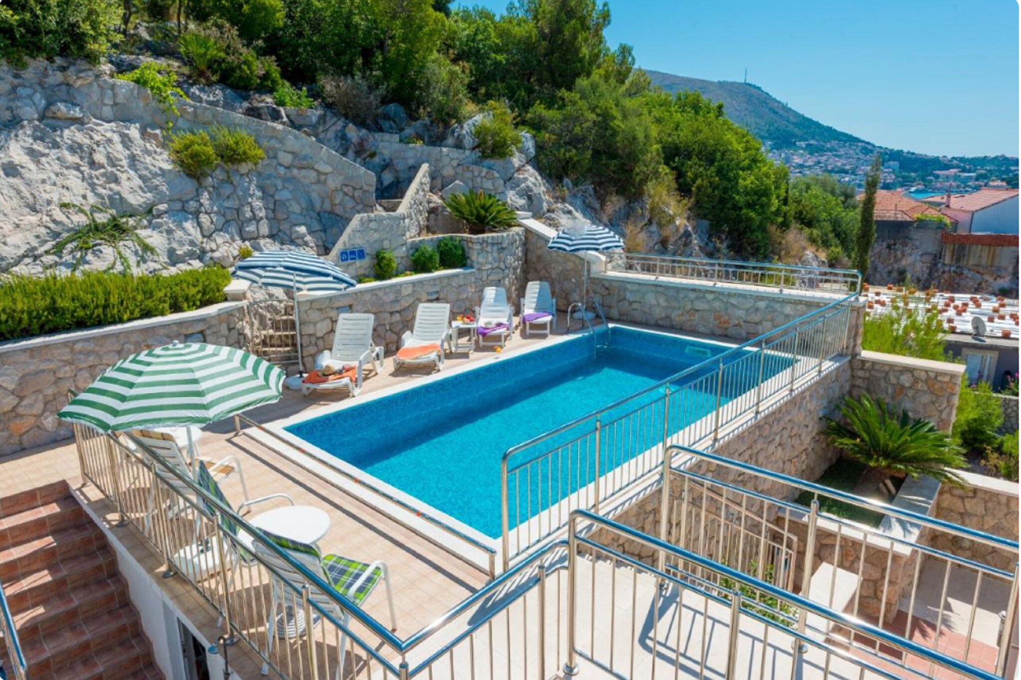 Villa Borna Apartments are situated in Babin Kuk neighborhood in Dubrovnik, 10 min drive away from the historic Old City and a short walk away from the best beaches Dubrovnik has to offer.
Spacious terrace fitted with sun beds and parasols as well as a common seasonal outdoor swimming pool and a shared garden are at your disposal, which makes this place ideal for a nice and relaxing family or friends vacation.
This lovely studio apartment with a shared furnished terrace is perfectly fit for up to two people where the twin beds can be joined together or separated. It features free WiFi, air conditioning as well as SAT LCD TV. The equipped kitchen comes with a dining area, and the private bathroom comes with a shower and toilet.
Free toiletries (shampoo, soap, and toilet paper), hairdryer, as well as linens and towels, are at your disposal.
If you want to spend your vacation in peace and quiet environment, far from the city crowds, and also to have nearby all you need during your holidays Villa Borna Apartments are the best choice for you. In the neighborhood, you will find grocery stores, cafes, restaurants, ATM's as well as children's playgrounds and the famous Lapad Promenade
A bus station with a direct line to the Old City of Dubrovnik is 120 meters away. Main bus station and ferry port are across the bay, 3 km drive away from the property while Dubrovnik Airport is 23 km away from the property.
