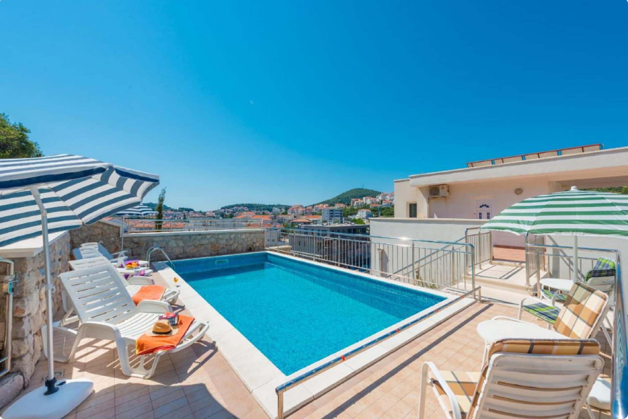 Villa Borna Apartments are situated in Babin Kuk neighborhood in Dubrovnik, 10 min drive away from the historic Old City and a short walk away from the best beaches Dubrovnik has to offer.
Spacious terrace fitted with sun beds and parasols as well as a common seasonal outdoor swimming pool and a shared garden are at your disposal, which makes this place ideal for a nice and relaxing family or friends vacation.
This lovely studio apartment with a shared furnished terrace is perfectly fit for up to two people where the twin beds can be joined together or separated. It features free WiFi, air conditioning as well as SAT LCD TV. The equipped kitchen comes with a dining area, and the private bathroom comes with a shower and toilet.
Free toiletries (shampoo, soap, and toilet paper), hairdryer, as well as linens and towels, are at your disposal.
If you want to spend your vacation in peace and quiet environment, far from the city crowds, and also to have nearby all you need during your holidays Villa Borna Apartments are the best choice for you. In the neighborhood, you will find grocery stores, cafes, restaurants, ATM's as well as children's playgrounds and the famous Lapad Promenade
A bus station with a direct line to the Old City of Dubrovnik is 120 meters away. Main bus station and ferry port are across the bay, 3 km drive away from the property while Dubrovnik Airport is 23 km away from the property.