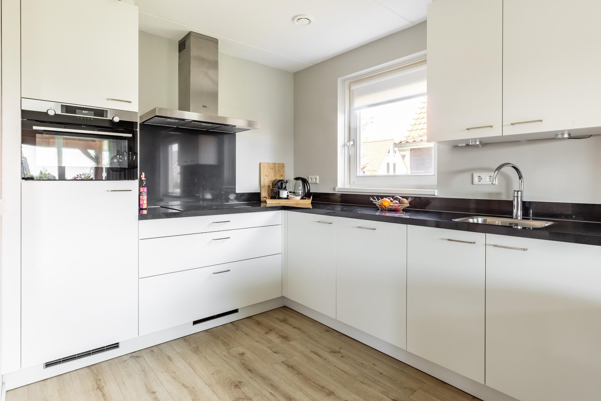 Ground floor: (hallway, open kitchen(hob(4 ring stoves, electric), cooker, hood, coffee machine, combination microwave, dishwasher, fridge-freezer), Living/diningroom(TV(smart TV), dining table, seating area), Bedroom with bathroom(double bed(boxspring), shower(walk-in shower), washbasin), toilet(toilet))\n\nOn the 1st floor: (bedroom(double bed or 2 single beds(boxspring)), bedroom(double bed or 2 single beds(boxspring)), bathroom(shower(walk-in shower), washbasin), toilet(toilet))\n\nterrace(private, roofed), garden(private), garden furniture, parking