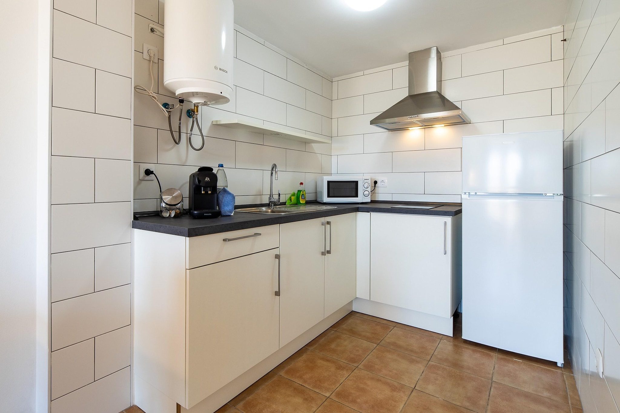 Ground floor: (Entrance, Kitchen(hob, hood, coffee machine, oven, microwave, fridge-freezer), Living/diningroom(TV(flatscreen), dining table, seating area, balcony or terrace), bedroom(double bed(150 x 200 cm)), bedroom(double bed or 2 single beds(90 x 200 cm)), bathroom(shower, washbasin, toilet, hairdryer), heating, air conditioning)\n\nAttic: (terrace(shared with other guests), parasol, hammock)\n\nwashing machine, iron