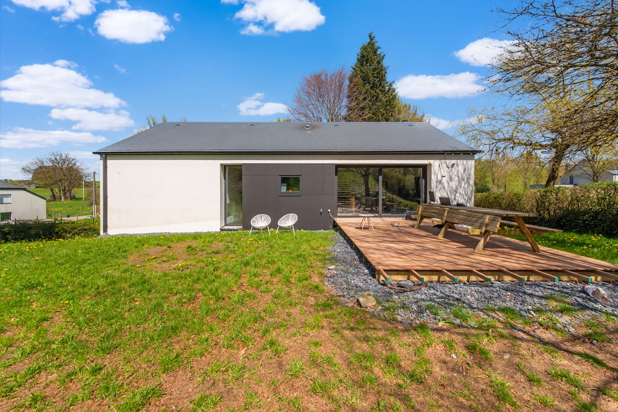 Ground floor: (Living room(TV, fireplace, seating area), Large kitchen(dining table, electric kettle, cooker, coffee machine, oven, microwave, dishwasher, fridge-freezer), bedroom(single bed, double bed), bedroom(double bed), bedroom(single bed, single bed), bedroom(single bed, single bed), bathroom(bath tub, washbasin, toilet))\n\nBasement: (bathroom(shower), playroom, sauna)\n\nrecreation room, bathtub or shower, sauna, washing machine, terrace, garden, garden, bicycle storage, garden furniture, BBQ, parking, party games