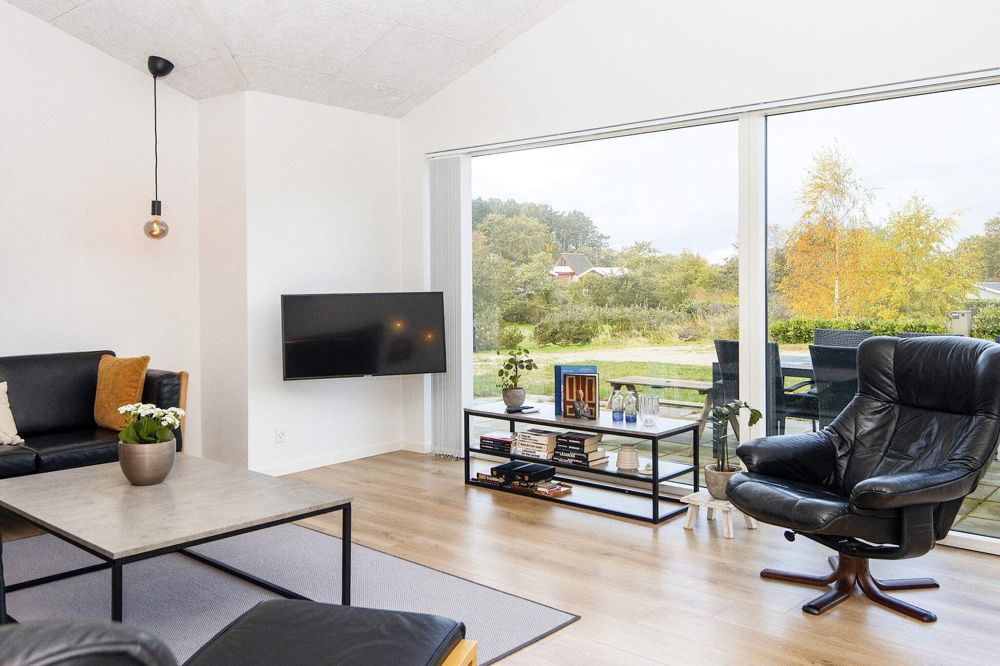 Nestled in the scenic Hegedal area near Skovgårde, this charming holiday home offers a perfect setting for family gatherings and outdoor fun. The spacious 55 m² open-plan kitchen and living area serves as the heart of the home, ideal for shared meals and quality time together. For entertainment, a 22 m² activity room with table tennis provides hours of indoor fun for children and adults alike. The house features four comfortable bedrooms and a well-equipped kitchen, ensuring a practical and enjoyable stay. With two bathrooms, including one with a convenient washer-dryer, and eco-friendly heating through geothermal energy, the property combines modern comfort with sustainability. Bright interiors and thoughtful design make it easy to relax indoors while staying connected to the natural surroundings. Outside, a 12 m² covered terrace and a 100 m² open terrace provide plenty of space to enjoy the fresh air, rain or shine. The 1,400 m² natural plot offers ample room for children to play safely, while the nearby beach, just 250 meters away, invites long days of sand and sea. With its combination of family-friendly facilities, outdoor space, and proximity to the water, this holiday home is an ideal base for a memorable coastal getaway. Please note: rental to youth groups is not permitted.A refundable deposit might be charged closer to your check-in date. The security deposit ensures a smooth stay and covers any additional services or consumption charges.This deposit covers utilities consumed during your stay and any additional services that may be taken.The final amount will be adjusted based on actual meter readings, actual usage of extra services, and any remaining balance will be refunded within 21 days after checkout.This deposit simply acts as a prepayment for charges that  you would anyways pay for, ensuring a seamless stay and check-out experience.