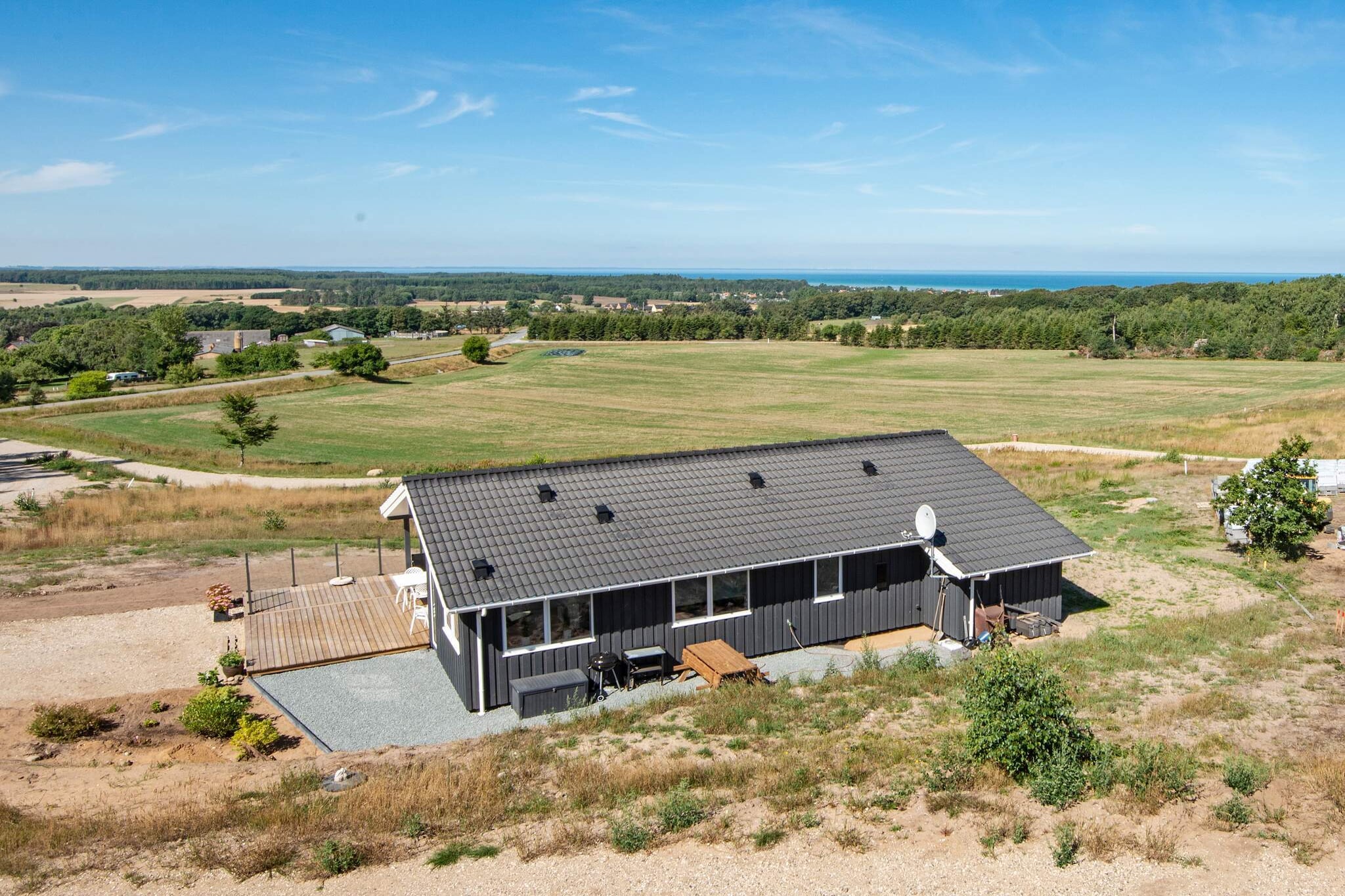 Perched on a hillside near Bønnerup, this charming holiday home offers breathtaking panoramic views of the Baltic Sea coast and a perfect setting for a relaxing getaway. Designed for comfort and well-being, the property features three bedrooms with quality beds and a cozy alcove for additional sleeping space. Two bathrooms ensure convenience, with one providing direct access to the private sauna and whirlpool, perfect for unwinding after a day of sightseeing or beach activities. A washing machine and dryer add extra practicality for longer stays. The well-equipped kitchen and adjoining dining area form a bright and welcoming hub for family life, ideal for shared meals and cozy gatherings. Large windows and an open layout allow natural light to fill the home, enhancing its warm and inviting atmosphere. Whether you’re preparing a home-cooked meal or simply enjoying a cup of coffee while taking in the views, the living spaces are designed for comfort and functionality. Outside, the 1,450 m² natural plot offers a 45 m² open terrace, perfect for sunny days, barbecue evenings, and enjoying the serene surroundings. The Bønnerup harbor is just a 10-minute walk away, where you can fish from the pier or stroll along the waterfront. With its combination of scenic location, family-friendly facilities, and wellness amenities, this holiday home provides an ideal base for an unforgettable coastal escape. Please note: rental to youth groups is not permittedA refundable deposit might be charged closer to your check-in date. The security deposit ensures a smooth stay and covers any additional services or consumption charges.This deposit covers utilities consumed during your stay and any additional services that may be taken.The final amount will be adjusted based on actual meter readings, actual usage of extra services, and any remaining balance will be refunded within 21 days after checkout.This deposit simply acts as a prepayment for charges that  you would anyways pay for, ensuring a seamless stay and check-out experience.