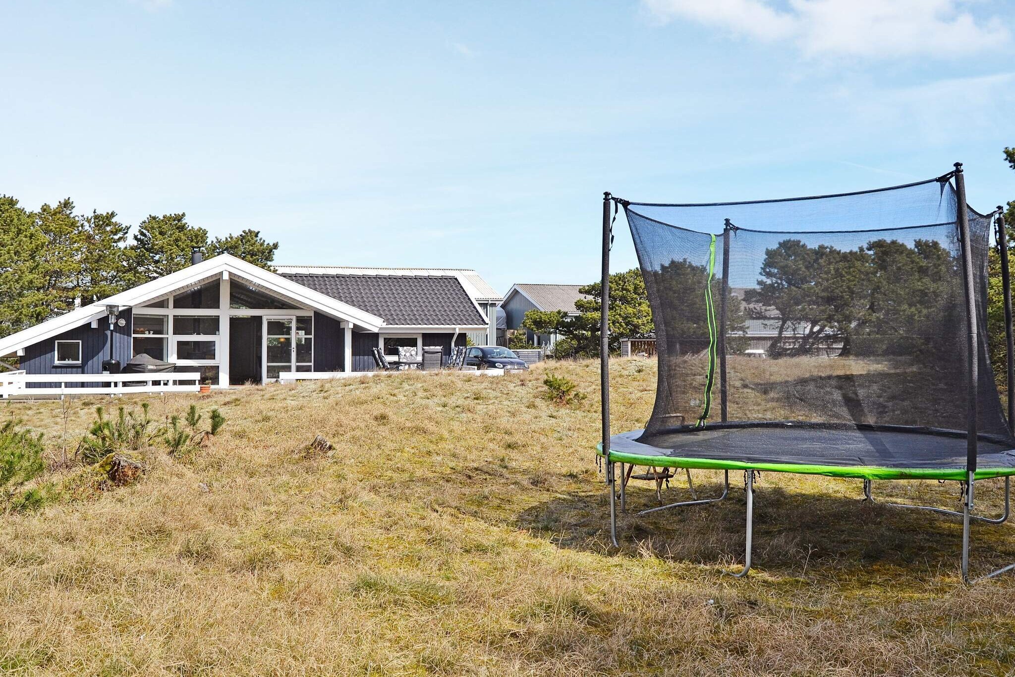 This inviting holiday home, located near Nordby on the island of Fanø, offers a relaxing retreat just 1,200 meters from one of Denmark’s widest North Sea beaches. Designed for comfort and wellness, the property features a whirlpool and sauna in the bathroom, making it easy to unwind after a day of seaside activities. A cozy wood-burning stove provides warmth during the cooler autumn and winter months, creating a welcoming atmosphere throughout the year. Inside, the house is comfortably furnished and well-equipped, providing a bright and pleasant environment for family life. Outside, a large terrace invites long summer evenings of relaxation, dining, and enjoying the tranquil surroundings. The spacious natural plot also includes a garden trampoline for children (use at own risk), ensuring fun for younger guests while adults soak in the peaceful atmosphere. Surrounded by Fanø’s beautiful nature, the location allows you to observe local wildlife, including deer, hares, and pheasants, adding to the charm of this coastal escape. Quietly situated at the end of a cul-de-sac, this home combines comfort, wellness amenities, and a prime natural setting, making it an ideal base for families and groups seeking both relaxation and adventure. Please note: rental to youth groups is not permitted.A refundable deposit might be charged closer to your check-in date. The security deposit ensures a smooth stay and covers any additional services or consumption charges.This deposit covers utilities consumed during your stay and any additional services that may be taken.The final amount will be adjusted based on actual meter readings, actual usage of extra services, and any remaining balance will be refunded within 21 days after checkout.This deposit simply acts as a prepayment for charges that  you would anyways pay for, ensuring a seamless stay and check-out experience.