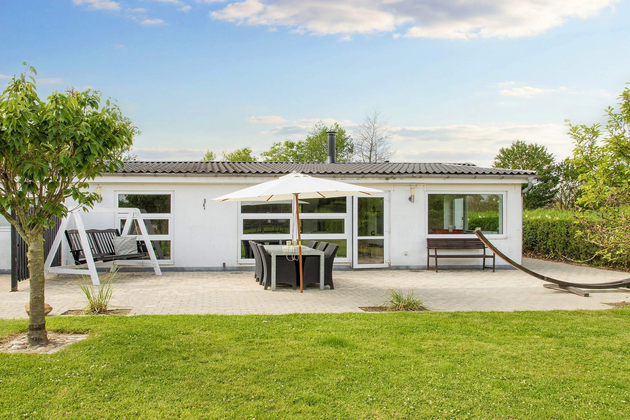 Just 50 meters from the beautiful sandy shores of Binderup lies this newly renovated holiday home, perfectly designed for families who want to combine comfort, relaxation, and coastal charm. The house has been thoughtfully modernized with a practical layout, making it easy to enjoy both everyday living and holiday pleasures. With three well-appointed bedrooms, there is plenty of space for everyone. The bright, spacious open-plan kitchen and living area forms the heart of the home, where large windows allow natural light to flood in and create a warm, inviting atmosphere. From here, you have direct access to one of the terraces, ideal for family meals or simply enjoying the fresh air. This property is all about variety and comfort. Surrounding the house are several terraces, so you can always find a sunny corner or a spot in the shade depending on the time of day. A highlight is the outdoor hot tub, where you can light the fire and sink into warm water while watching the stars above – an unforgettable experience after a day at the beach. Inside, children and adults alike will enjoy the foosball table located in the large entrance hall, which adds an extra touch of fun to family evenings. The combination of modern interiors and outdoor relaxation areas makes this house equally suitable for cozy off-season stays and vibrant summer holidays. The outdoor spaces are just as inviting. A southwest-facing terrace creates a sheltered patio-like atmosphere, perfect for quiet afternoons or evening barbecues. In front of the house, a large lawn offers plenty of space for games, sports, and playtime. A garden trampoline is also available for the children, though use is at your own risk. Within just a few minutes’ walk you can reach Binderup Beach, a child-friendly sandy shoreline ideal for swimming, sandcastles, and relaxed summer days. Please note that the home is not rented to youth or worker groups. New photos showcasing the fresh renovation will be available soon.A refundable deposit might be charged closer to your check-in date. The security deposit ensures a smooth stay and covers any additional services or consumption charges.This deposit covers utilities consumed during your stay and any additional services that may be taken.The final amount will be adjusted based on actual meter readings, actual usage of extra services, and any remaining balance will be refunded within 21 days after checkout.This deposit simply acts as a prepayment for charges that you would anyways pay for, ensuring a seamless stay and check-out experience.