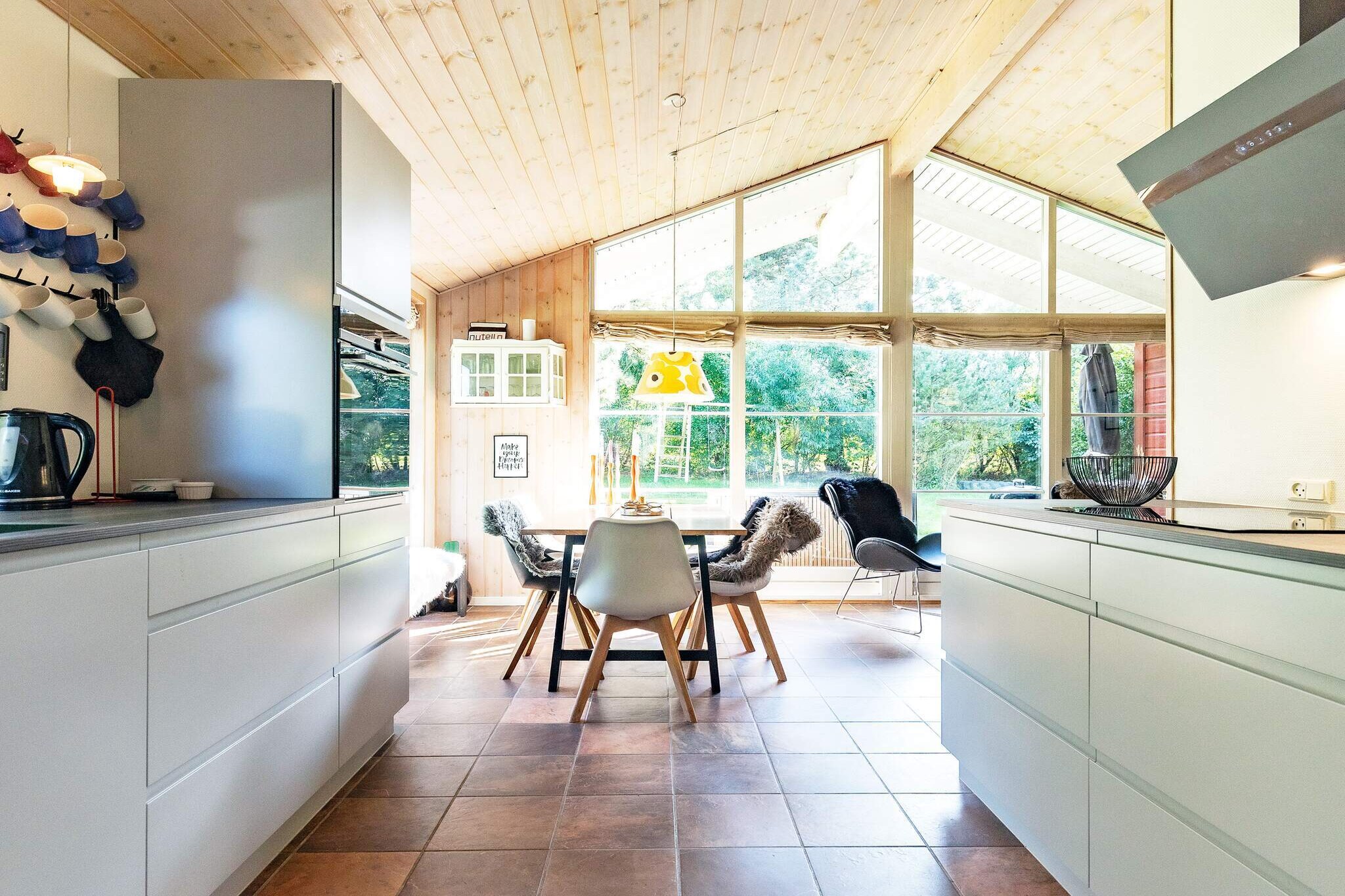 The garden offers ample opportunity to enjoy your vacation in peace and quiet, as well as opportunities for play. There are hammocks, a playhouse, swings, a sandbox, etc. In addition, there are several cozy nooks that are perfect for reading a good book while the kids play in the garden. There is also a fire pit where the family can enjoy roasting marshmallows and sausages and baking bread on a stick.

The house is also an activity center with plenty of entertainment for the whole family, including table football, billiards, and air hockey (table model). There are also darts.

The vacation home is bright and inviting and practically furnished with a combined living room/kitchen.

The living room has modern furniture, free high-speed internet, and a flat-screen TV with Chromecast, where you can stream your own TV services.

New high-quality kitchen with ceramic hob, separate oven with grill, extractor hood, microwave, coffee machine, fridge/freezer with at least 60 liters of freezer capacity, and dishwasher.

Bathroom with shower, bath, and toilet. There is a washing machine and dryer in the house.

The house has three bedrooms, all with double beds, and two single beds in the annex. The house also has a loft, which is primarily used for storage.

The house has both open/covered terraces with good garden furniture, sun loungers, and a barbecue, where you can enjoy dinner while the sun sets over the area. Not available for rental to youth groups.