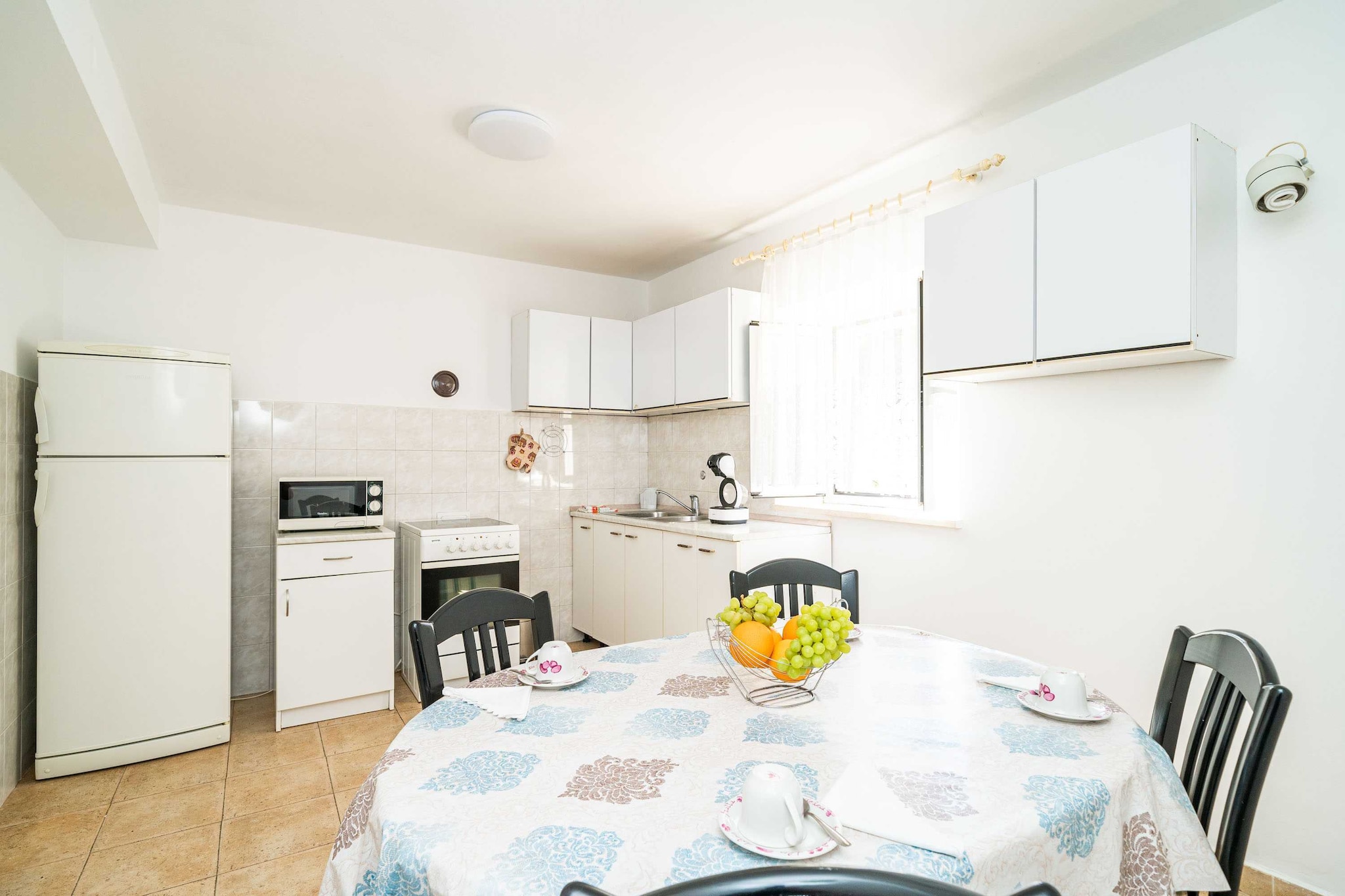 Apartment Kos  is situated in Lapad neighborhood only 3 km away from the historic Old Town and a short walk away from the best beaches Dubrovnik has to offer.
Shared garden, BBQ facilities as well as an outdoor dining area are at your disposal, which makes this place a perfect spot for a nice and relaxing family or friends vacation. 
Free Wi-fi is available thorough the property. 
Washing machine, iron and ironing board are at your disposal. 
Pets are allowed upon request at additional surcharge of 10 euros per pet per day, maximum 2 pets per stay.
Free private parking is provided, reservation is not needed.
Luggage storage is possible prior to check in and after check out, so you can explore the city a little more before your departure.
The property exterior is under video surveillance.

This two-bedroom apartment with a terrace can accommodate up to four people. It features air-conditioning as well as SAT LCD TV.  The kitchen is well equipped with an  oven, refrigerator, microwave, freezer, coffee maker, kitchen utensils and dining area. One bedroom is furnished with a large double bed, while the other one comes with two single beds. Free toiletries hair dryer as well as linens and towels are at your disposal.
It is located on the ground floor.

If you want to spend your vacation in a peaceful and quiet environment, far from the city crowds, and also to have nearby all you need during your holidays, Apartment Kos are the best choice for you. In the neighbourhood you will find grocery stores, cafes, restaurants, ATM's as well as children playgrounds and the famous Lapad Promenade is just 600 meters away from the accommodation.

Dubrovnik Bus Station and Ferry Port, connecting the mainland with various Dalmatian islands, are 3 km from the apartment, while Dubrovnik Airport is 25 km away.