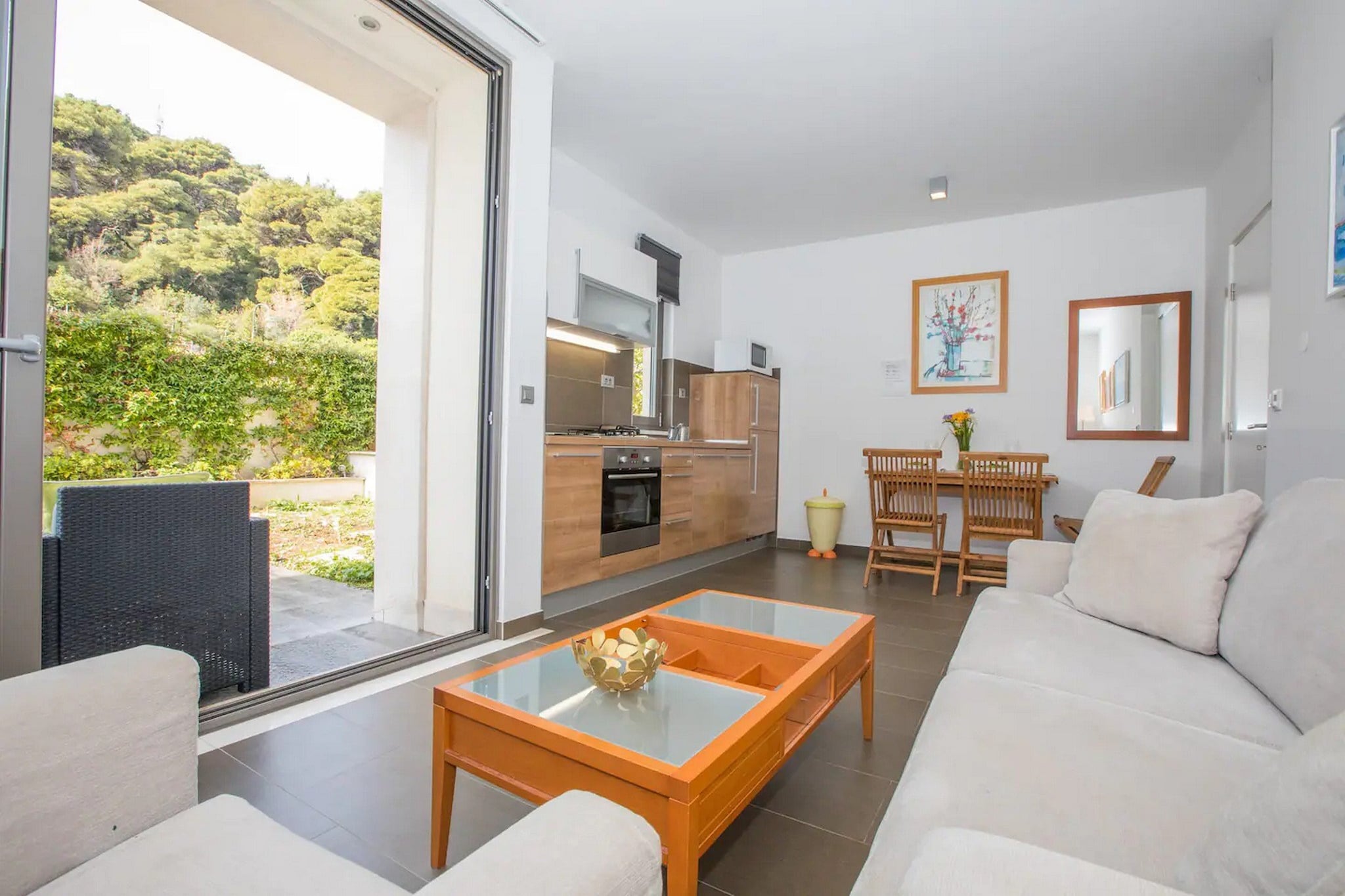 City Holiday Apartment is situated in Lapad bay is only 300 meters walk away from the beach and 10 minute ride from the Old Town, with a terrace overlooking the garden, perfect for a relaxing family or friends' vacation. 
Free private parking is provided, reservation is not needed.
Luggage storage is possible prior to check-in and after check out, so you can explore the city a little more before your departure.

This lovely one bedroom apartment with furnished terrace is perfectly fit for two people. It features free WiFi, air conditioning as well as LCD TV. The open space living room comes with sofa and sitting area, and it's combined with the equipped kitchen and dining area. The private bathroom comes with shower and toilet. Free toiletries, hair dryer as well as linens and towels are at your disposal. You have access to iron and ironing board.

Many shops, restaurants, cafes, parks and a famous promenade are a 5-minute walk away, as well as tennis courts, green market and a movie theater. There are also many beaches in the nearby area waiting for your discovery.

Dubrovnik Bus Station and Ferry Port, connecting the mainland with various Dalmatian islands, are 10 minutes ride from the apartment. Airport is 23 km away.